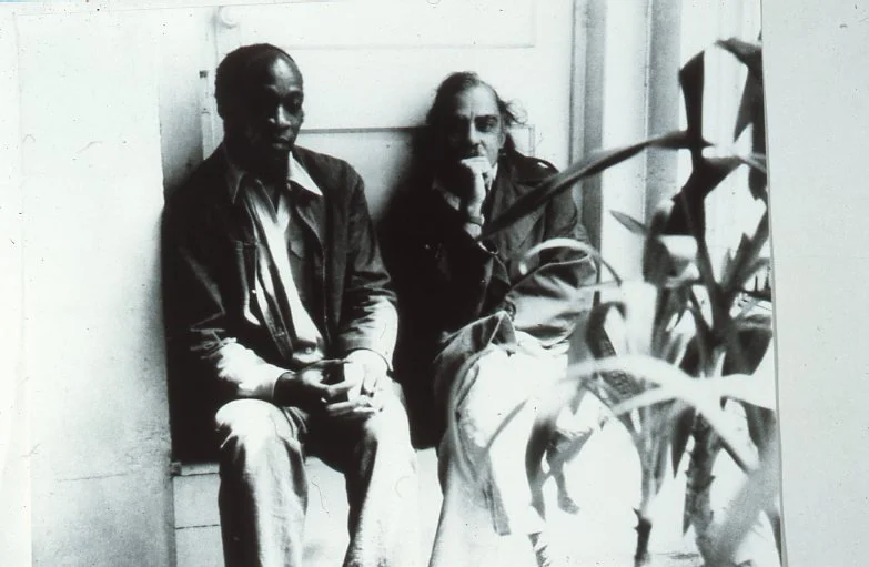 Hutson and Ed Clark sitting in front of Hutson's Studio, New York, 1977-1968