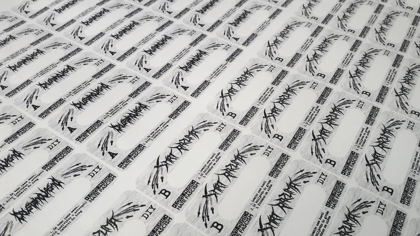 Multiple sheets of paper with a logo and text, arranged in a grid pattern. The logo resembles graffiti or stylized text and the accompanying text includes terms like 'DIY,' 'A,' 'B,' and 'HATE FASCISM.'