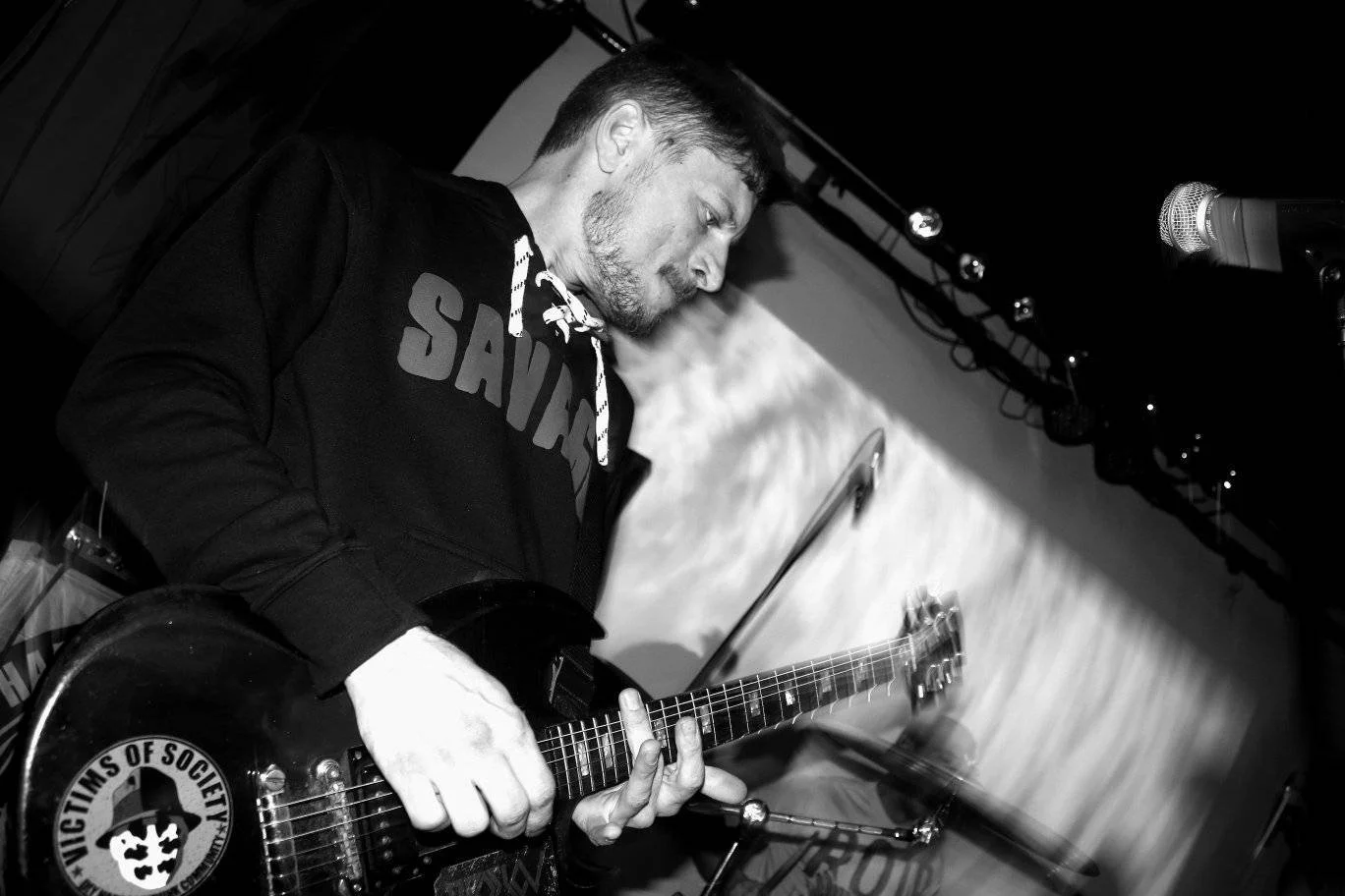 Man playing an electric guitar during a live performance on stage.