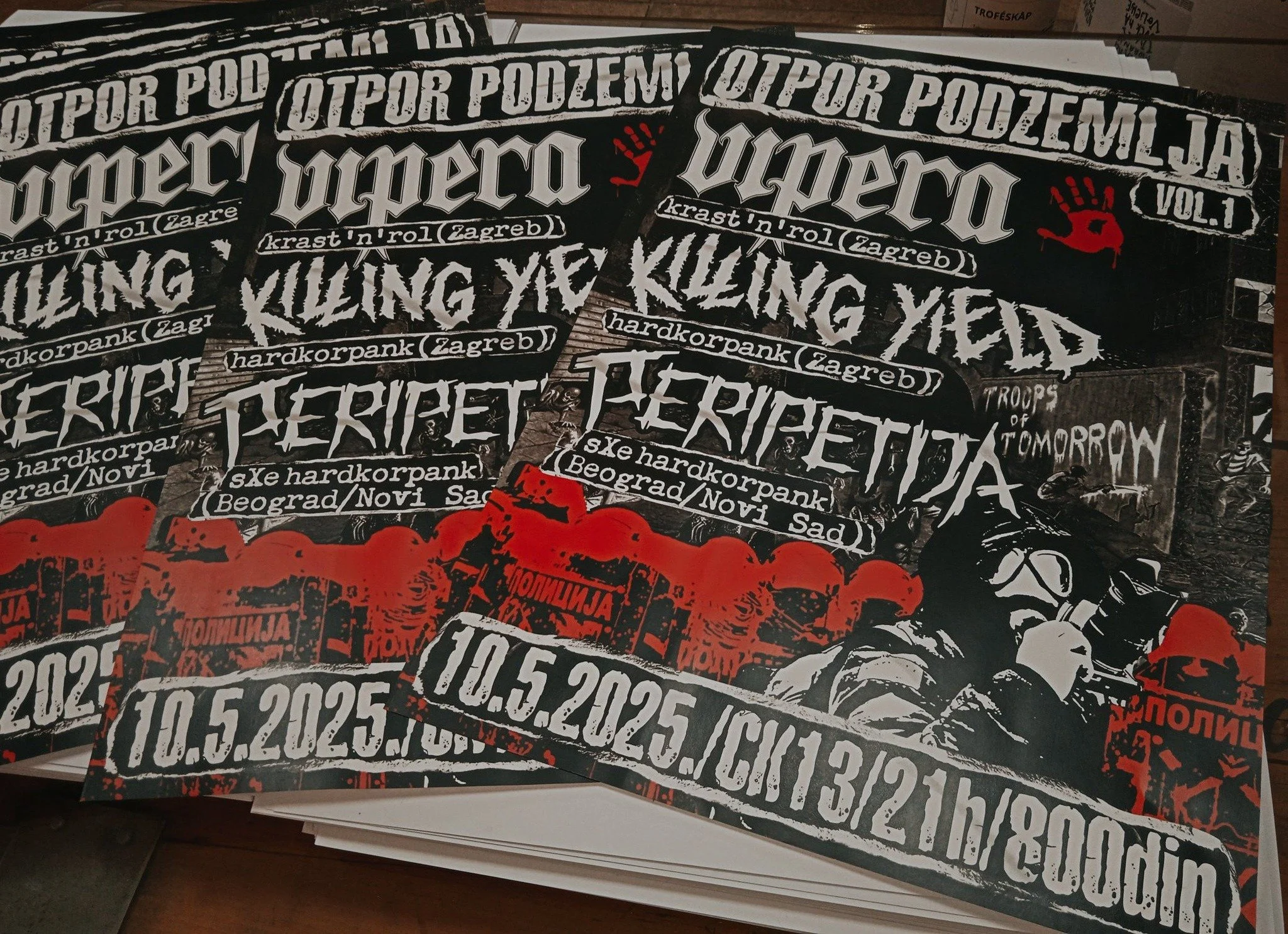 Stack of black posters with white and red text and graphics, promoting punk concerts and events in Zagreb, Croatia, including dates and locations.