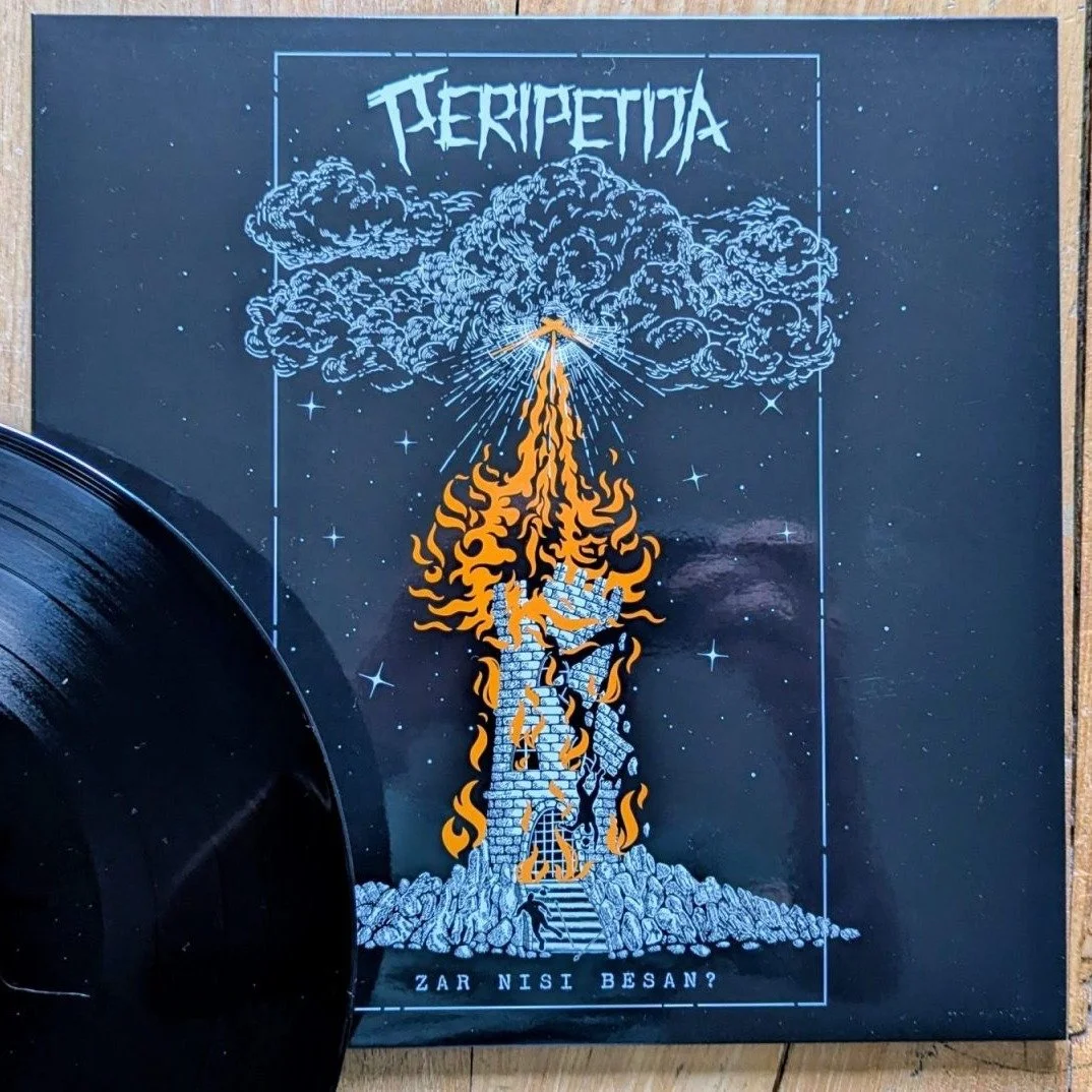 An album cover with a stylized illustration of a burning stone tower with flames reaching into the sky, emitting smoke shaped like clouds and an explosion effect at the top, set against a starry background. The band name Peripetija.