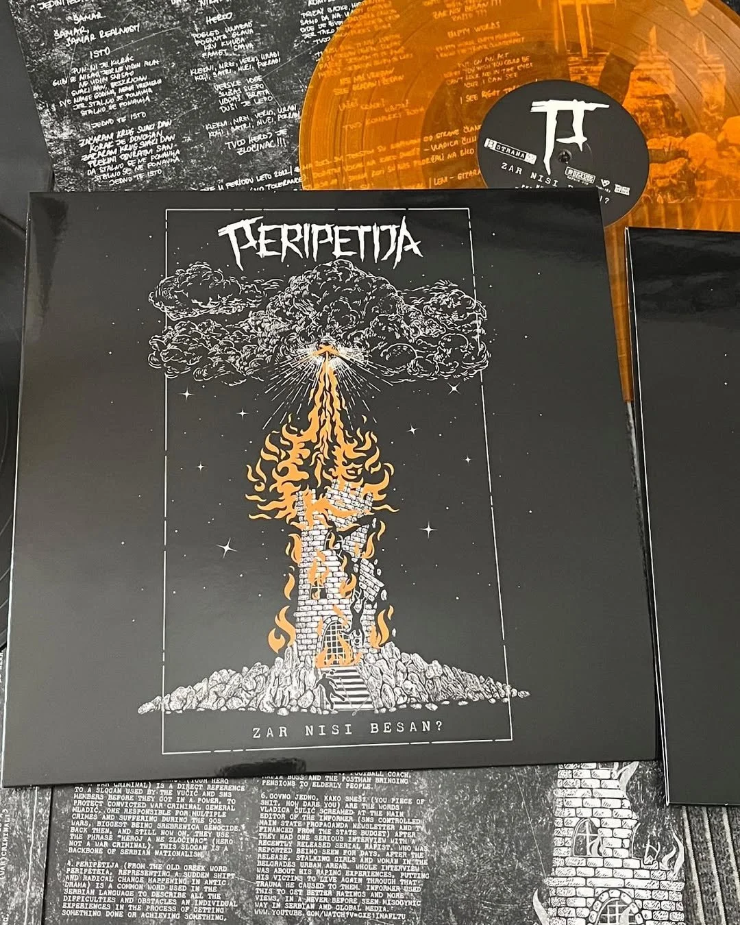 A black album cover with an illustration of a mushroom cloud explosion, emitting flames and smoke, with a black and white castle at the base, surrounded by stars. The band's name "Peripetija" appears at the top.
