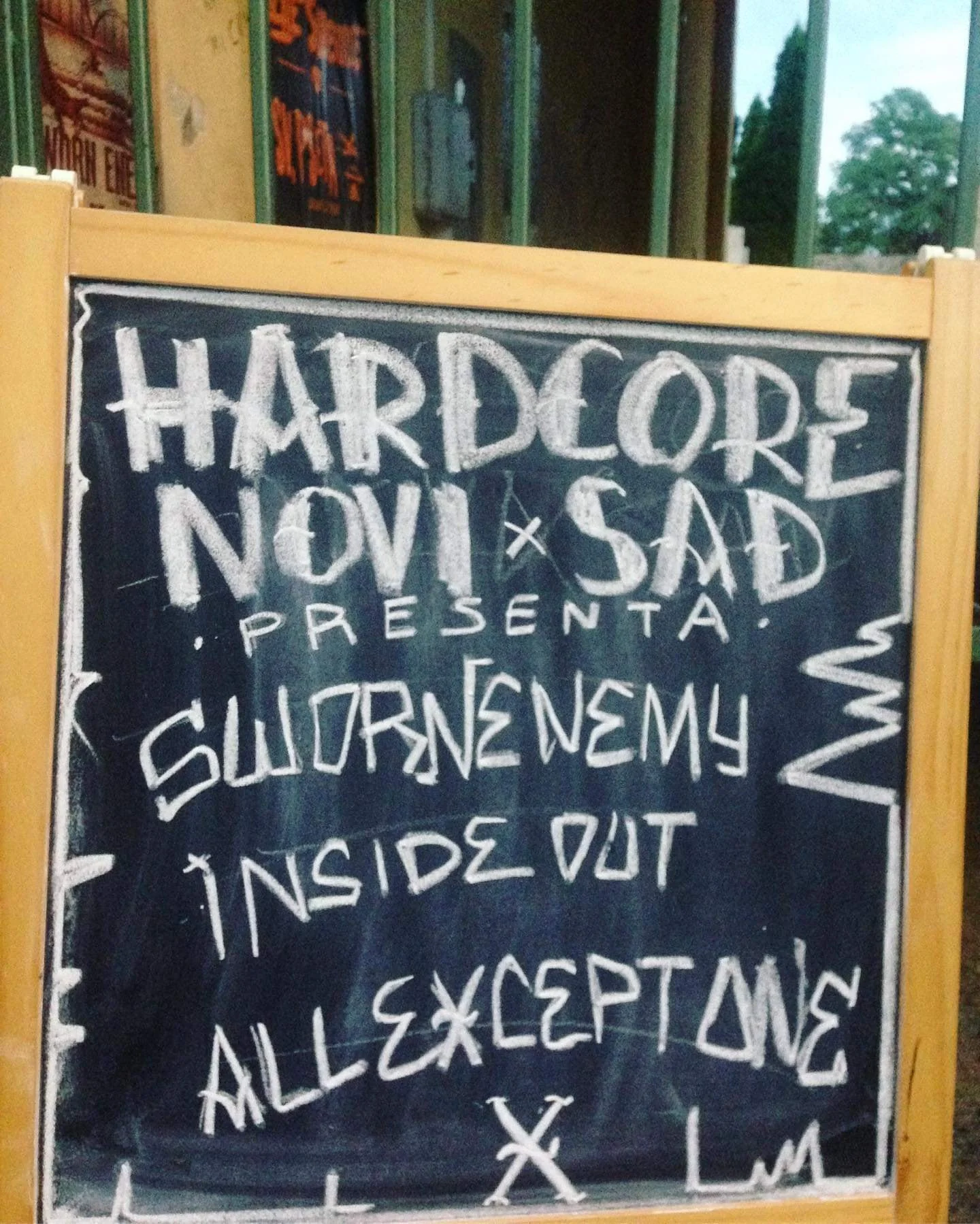 A chalkboard sign outside a restaurant featuring handwritten menu items and specials.