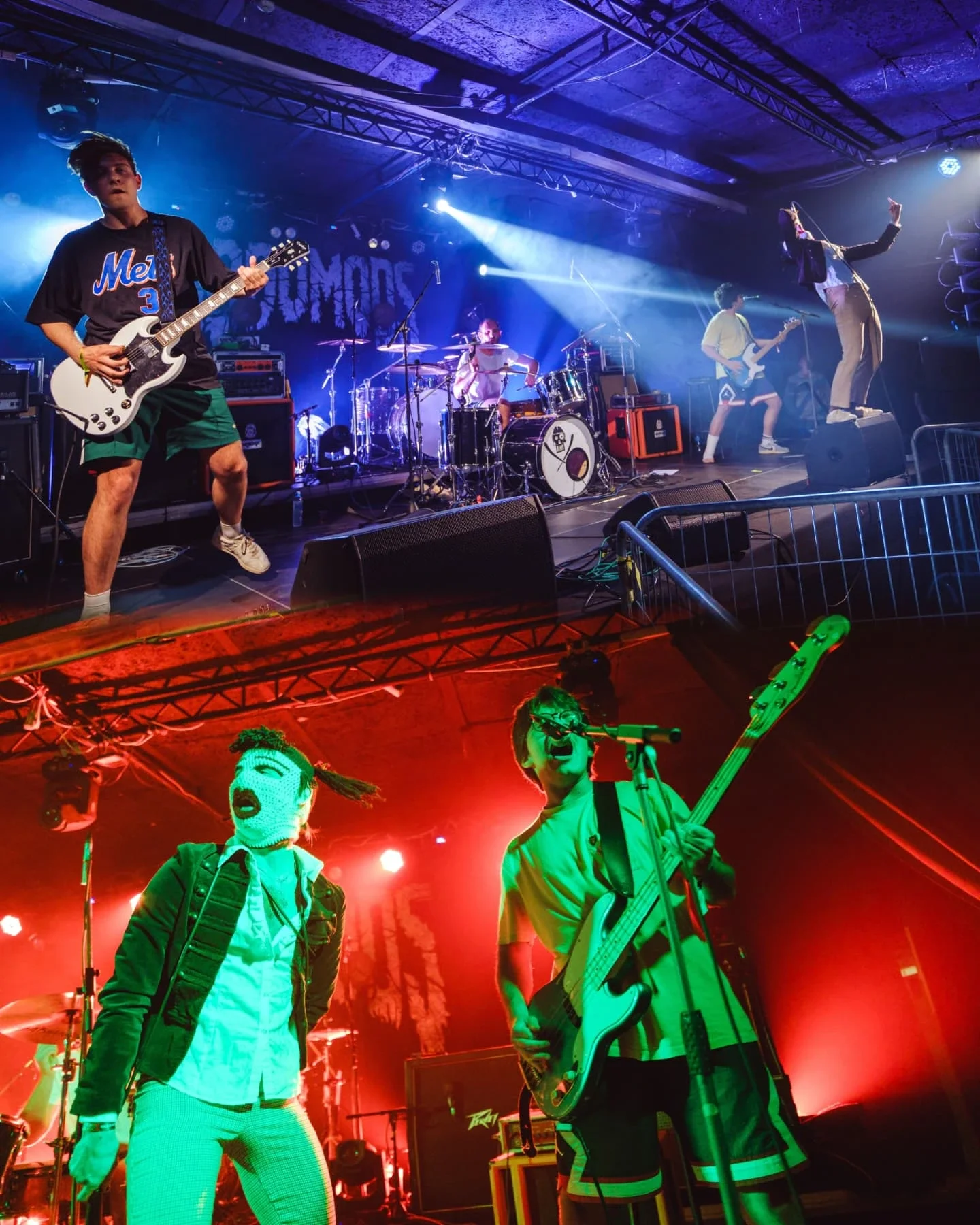 A band performing on a stage with blue and red lighting, including a guitarist, drummer, bassist, and a singer, with some animated figures in the foreground.