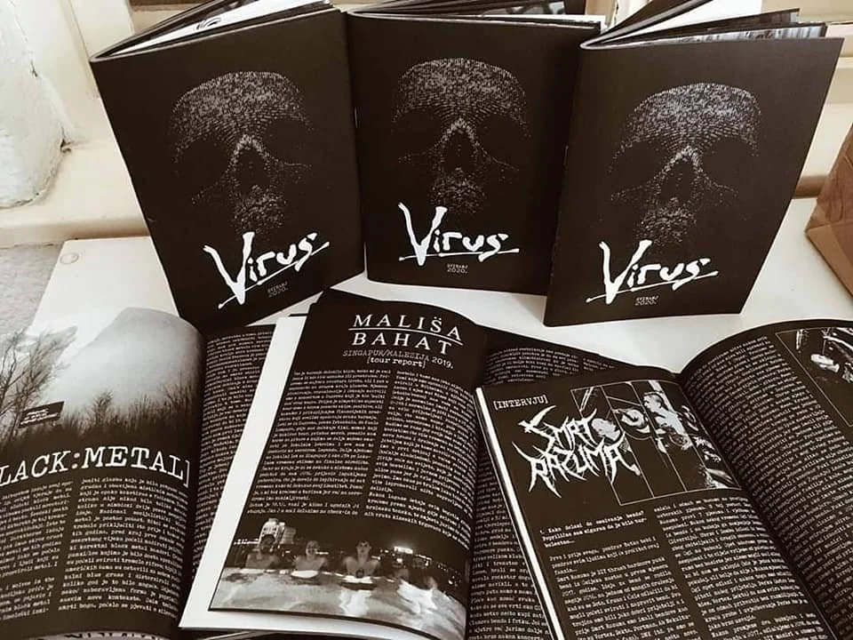 Open magazines on a table, one with the cover titled 'Virus' featuring a skull graphic, and another with an interview article with Mališa Bahat and a feature on metal music.