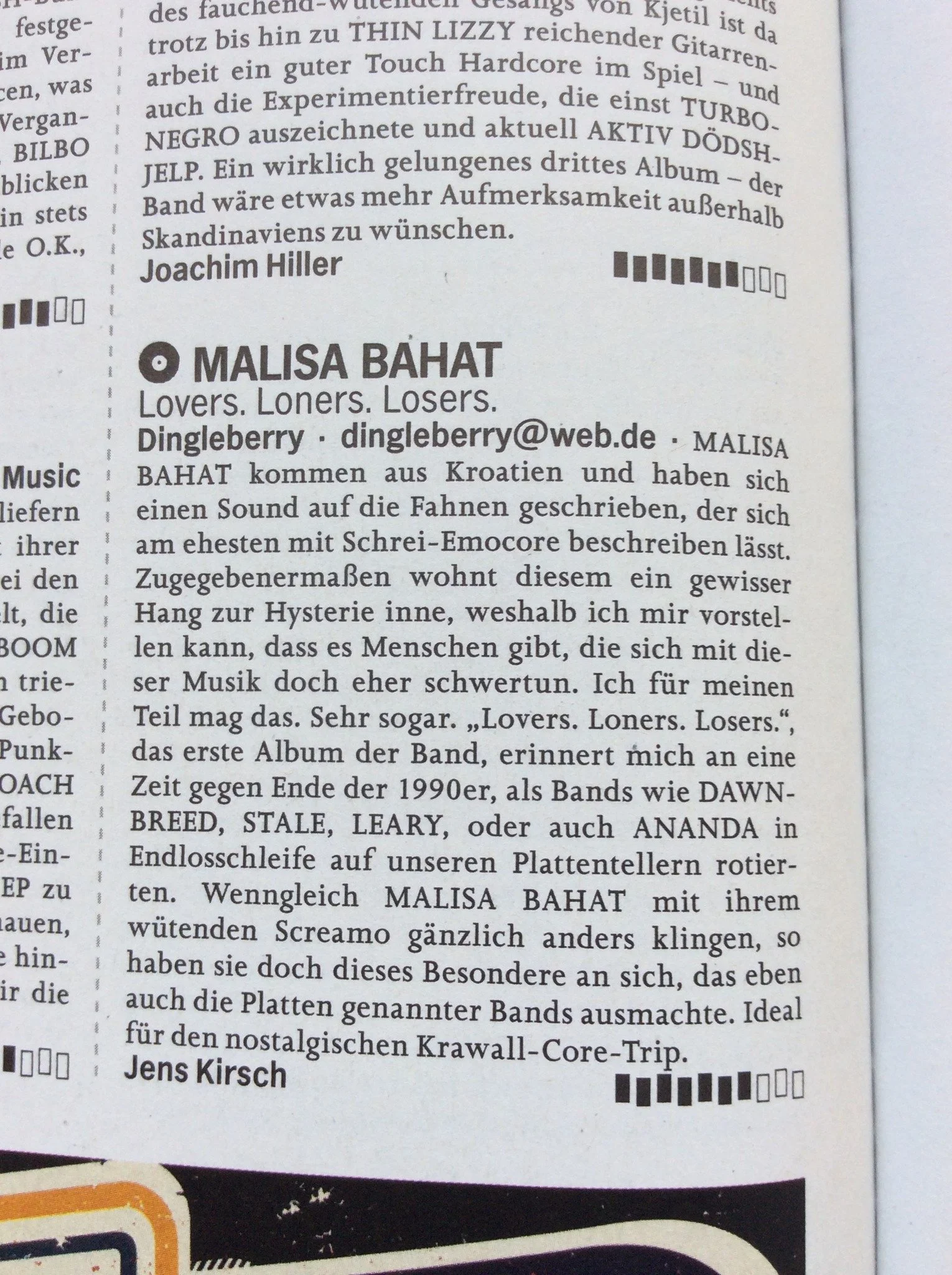Close-up of a newspaper page with German text, discussing music bands and a person named Malisa Bahat.