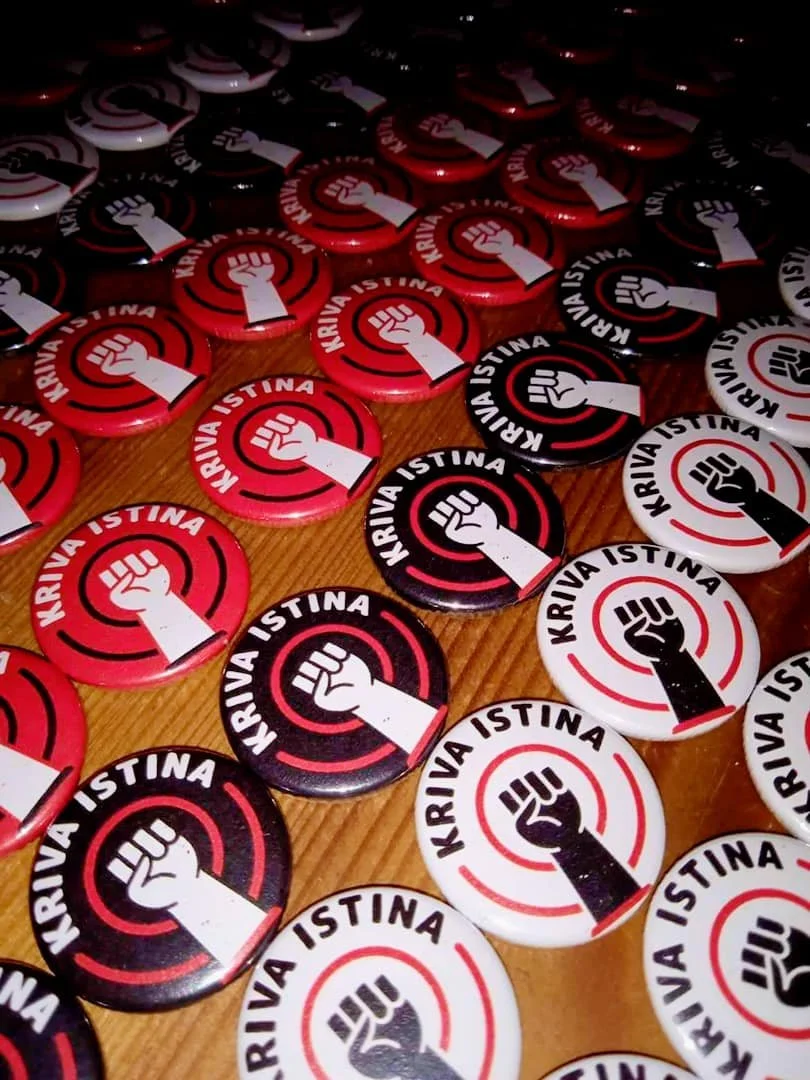 Collection of campaign badges featuring a clenched fist and the text 'KRIVA ISTINA' in red, black, and white colors.