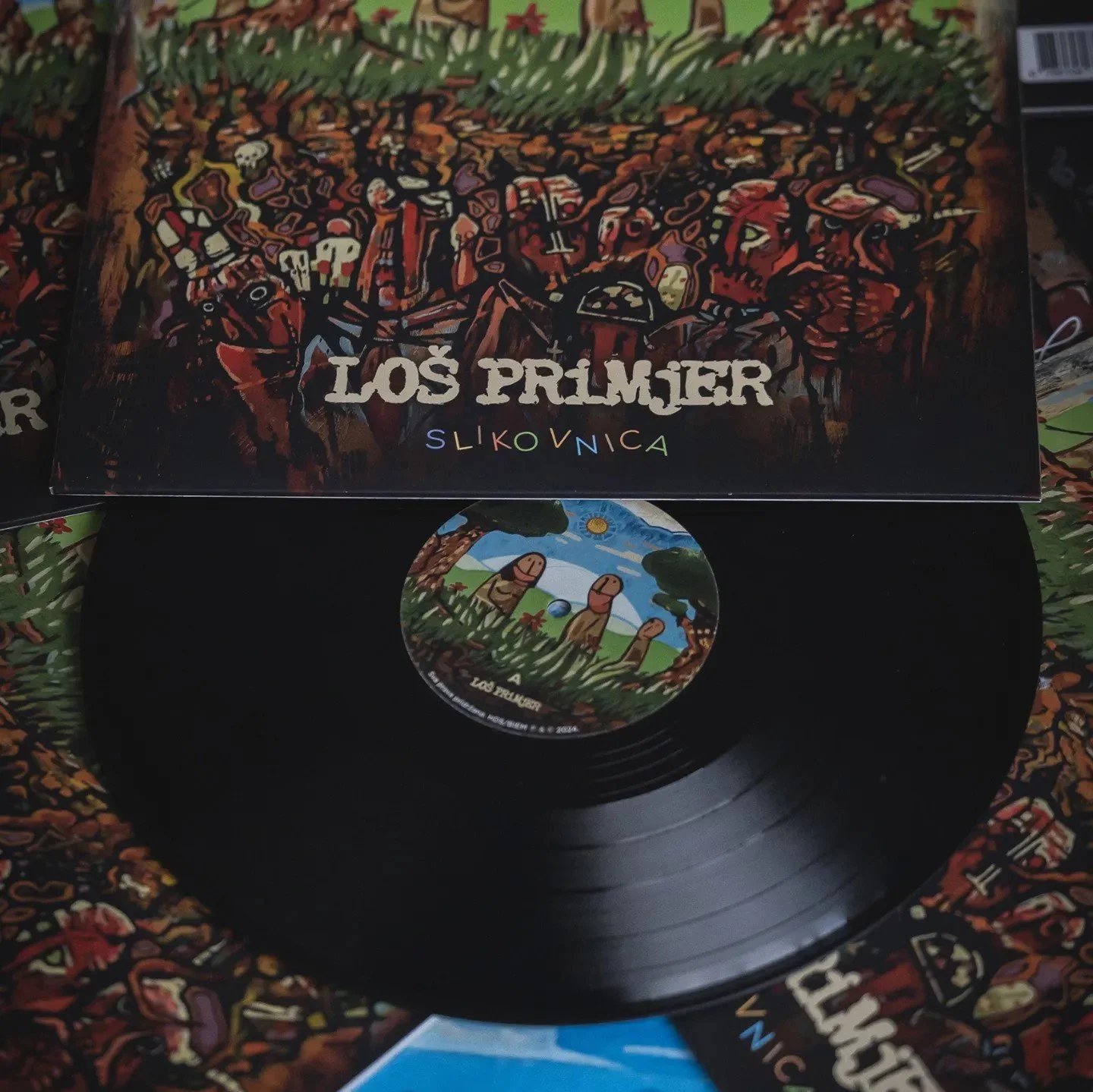 Vinyl record with album cover titled "Los Primjer" by Slikovnica, featuring colorful artwork of a forest scene with mushrooms and skulls.