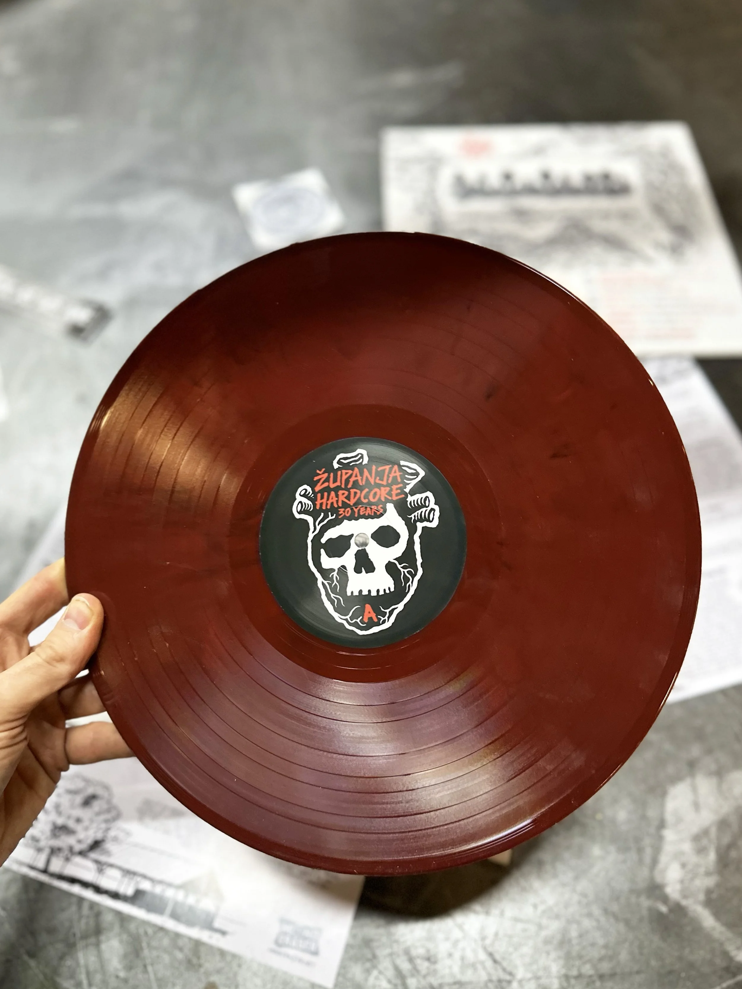 Red vinyl record with a skull and logo labeled 'Zupanja Hardcore 30 Years'.