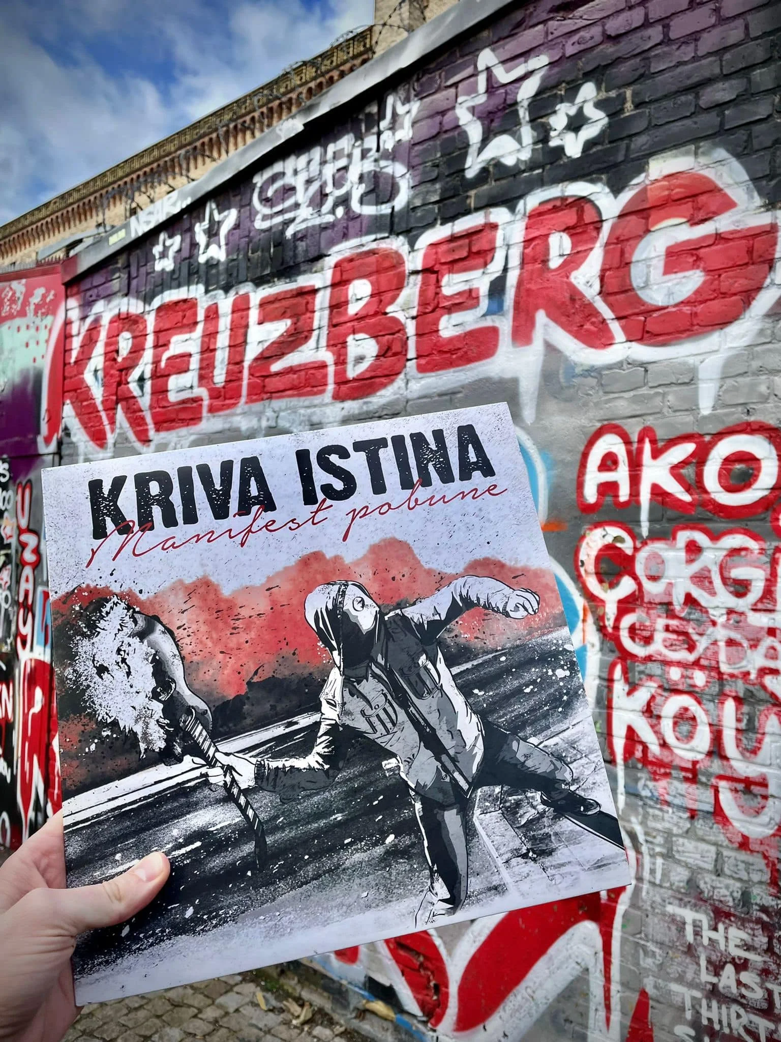 A poster depicting two police officers in riot gear running on a street, with a fiery explosion in the background.