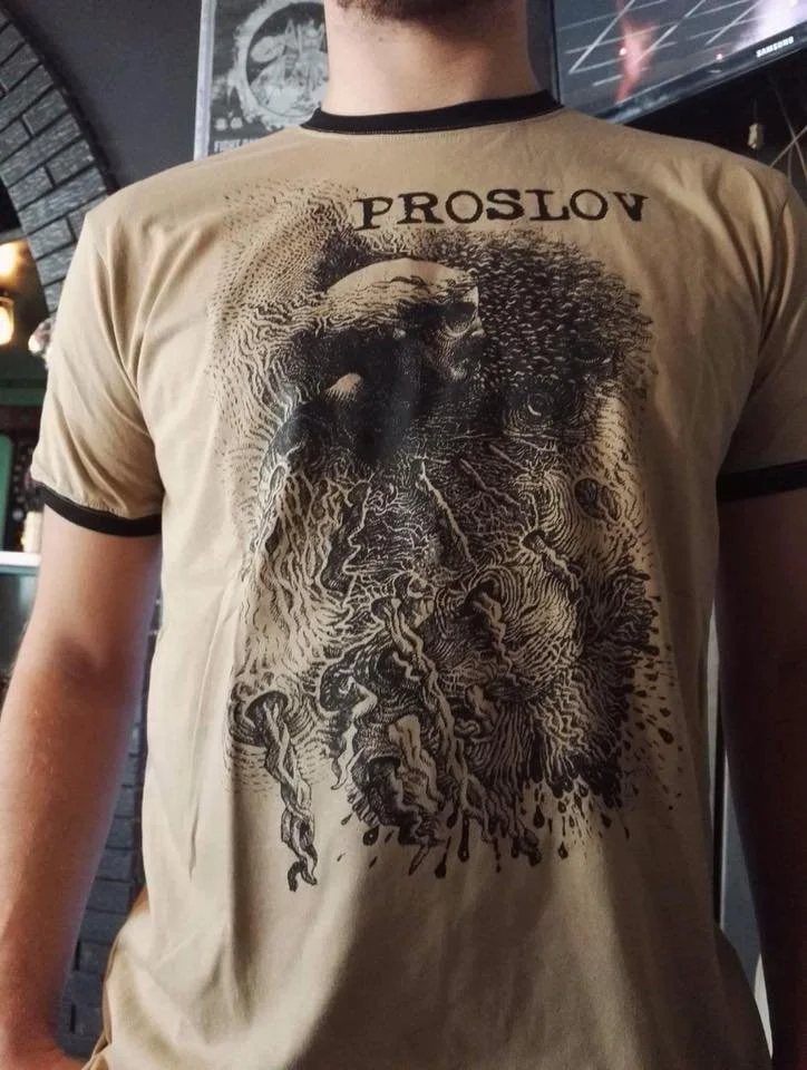 A beige T-shirt with a detailed graphic of a lion's face and mane, with the name 'PROSLOV' printed above it.