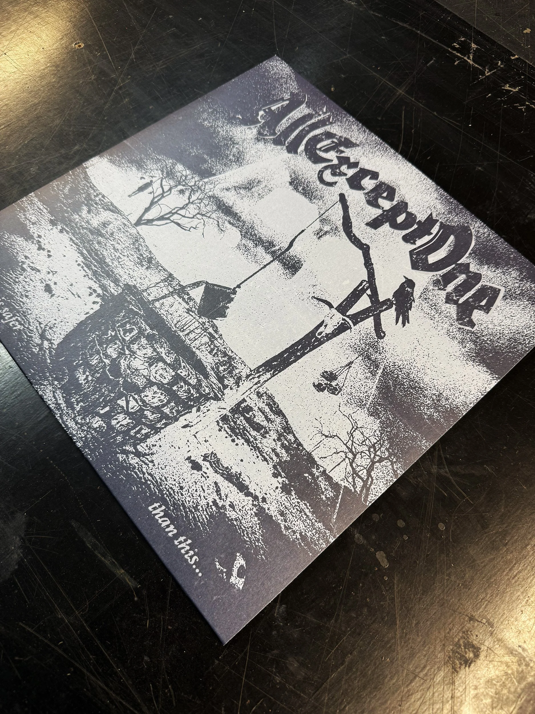 A black and white printed flyer or pamphlet with a winter or snow scene. The flyer is placed on a dark, textured surface.