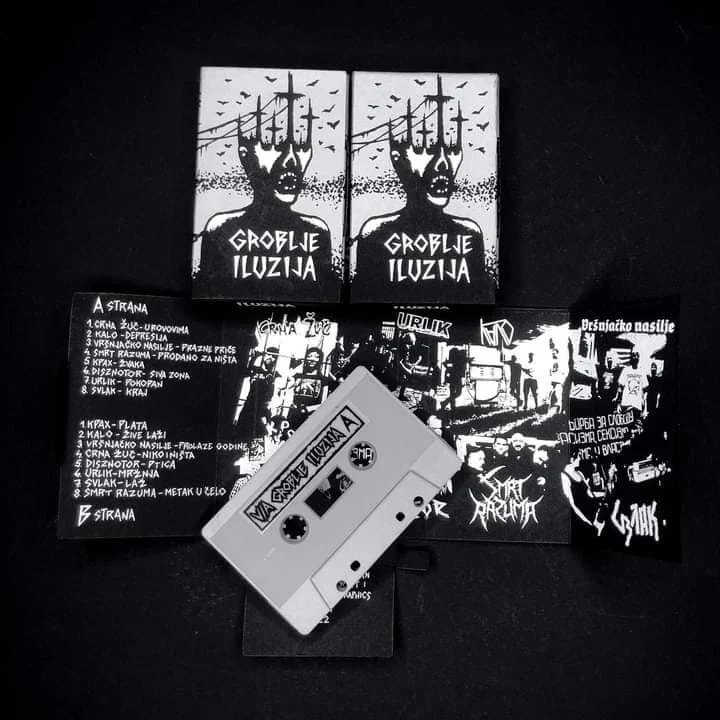 Black and white cassette tape with album artwork, two black CDs with artwork, and several black lyric inserts featuring graffiti-style art and text in a foreign language, all arranged on a black surface.