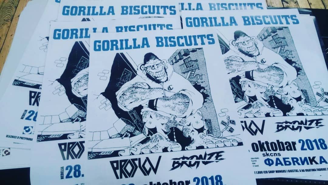 Flyers advertising the Gorilla Biscuits concert in October 2018 with a cartoon gorilla character wearing a hoodie, crossed arms, and a smile, standing against a cityscape background.