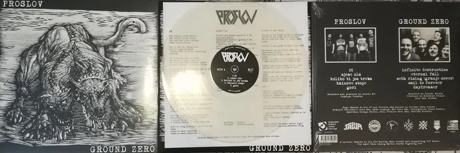 Image of a vinyl record album titled 'Ground Zero' by the band 'Prosvl.' The record is in a sleeve with lyrics or information. The cover features a detailed black and white illustration of a ferocious creature resembling a lion with a snake wrapping 