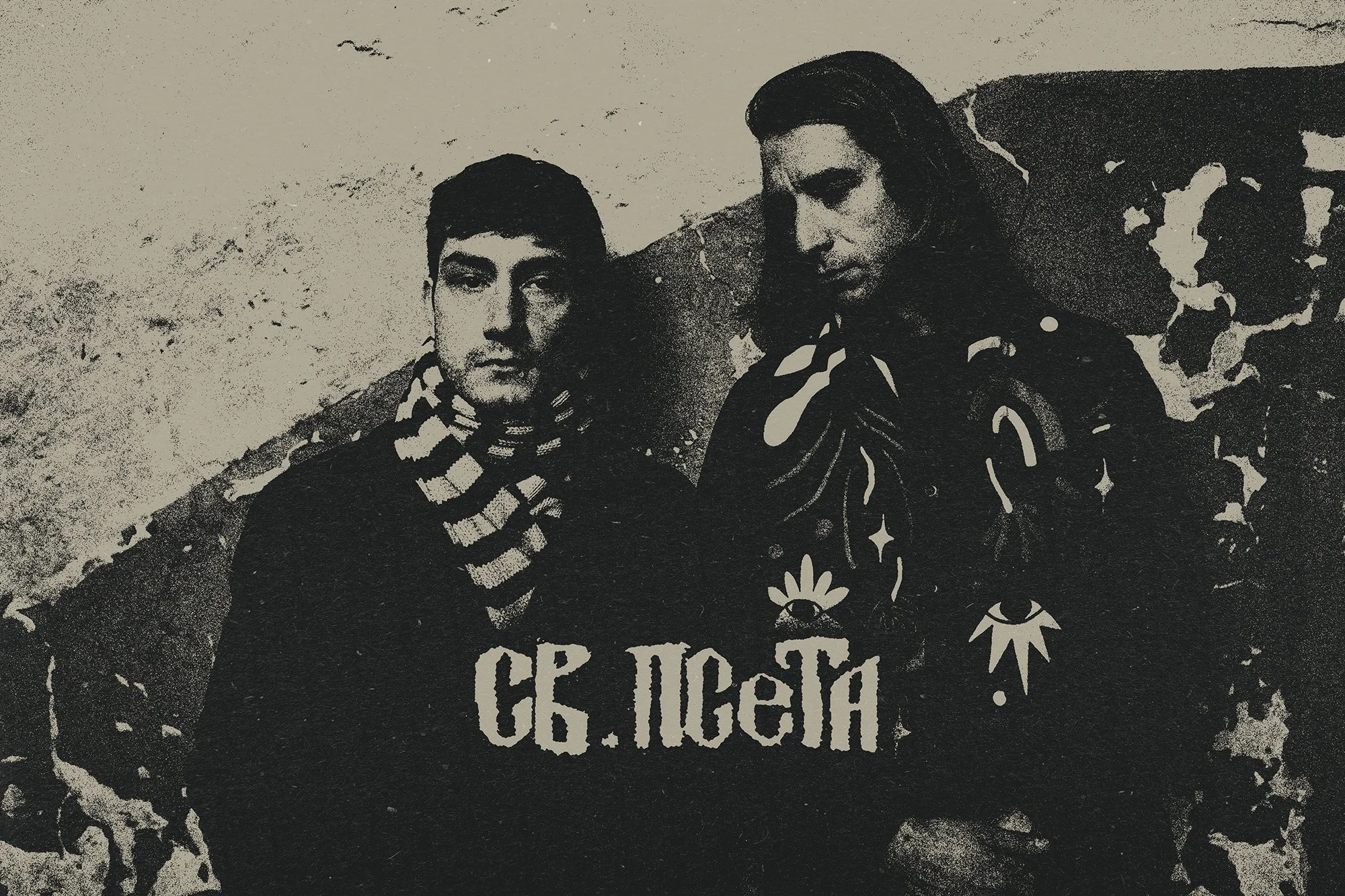 Black and white photograph of two young band members from SV. PSETA standing outdoors against a textured wall.