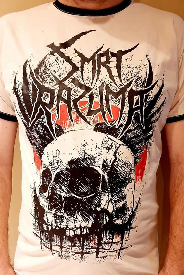 A person wearing a white T-shirt with a black and red graphic design of a large skull and stylized text above it.