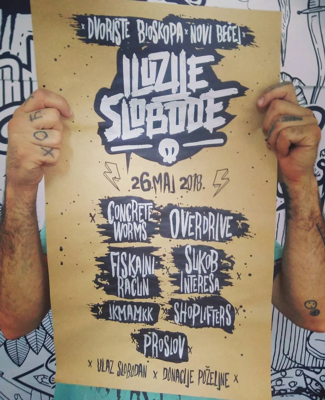 Event poster for a music festival called Iluzije Slobode, held on May 26, 2018. The poster features a yellow background with black and white graffiti-style text and illustrations, listing bands and performers.