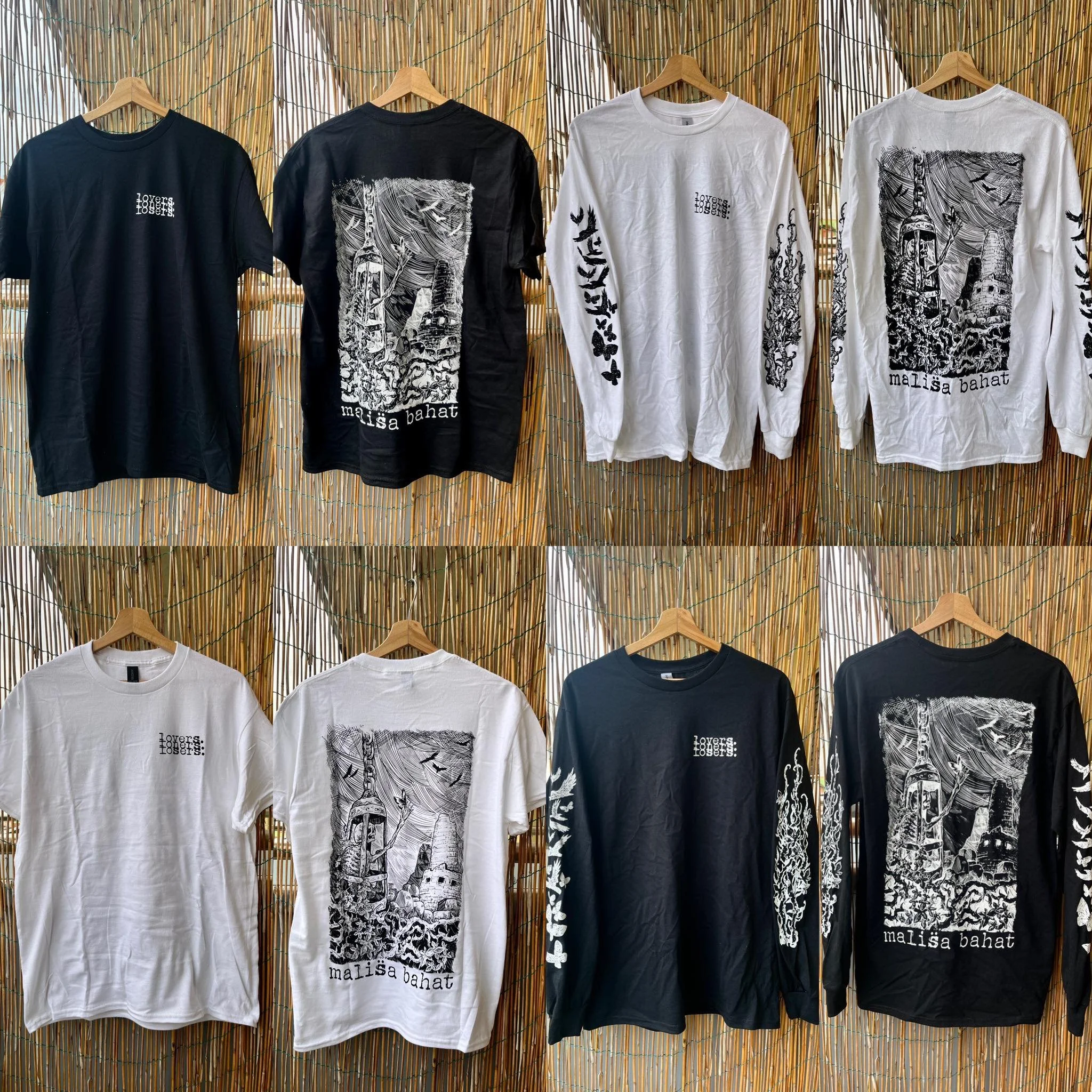 Several T-shirts hanging on wooden hangers against a bamboo backdrop. The T-shirts are in black and white with artistic designs and text.