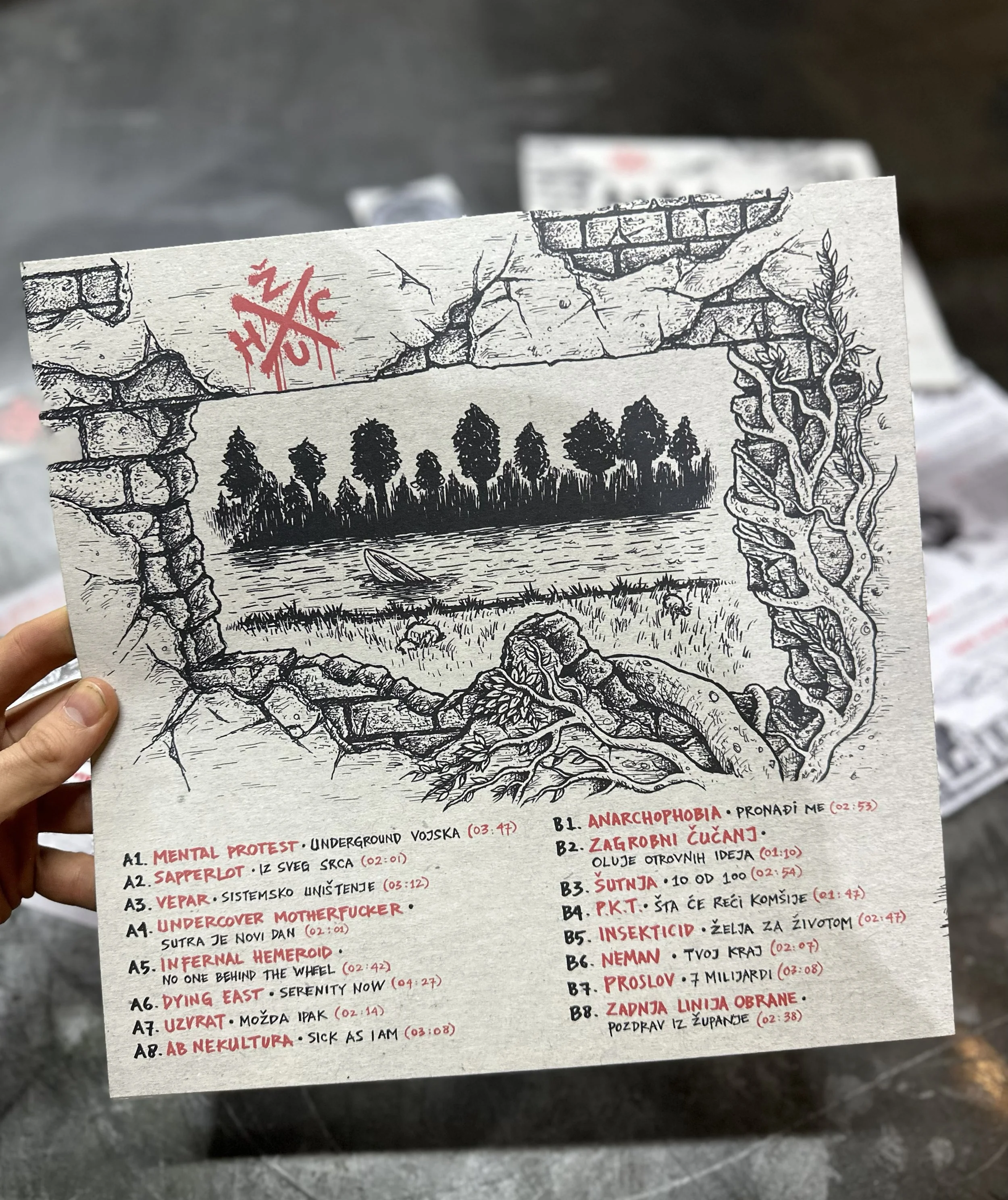 A black and white illustrated poster with a cracked wall, trees, and roots. The poster includes a list of items with titles such as "MENTAL PROTEST," "SAPPERLOT," and "UNDERCOVER MOTHERFUCKER," along with additional text and timestamps in red and bla