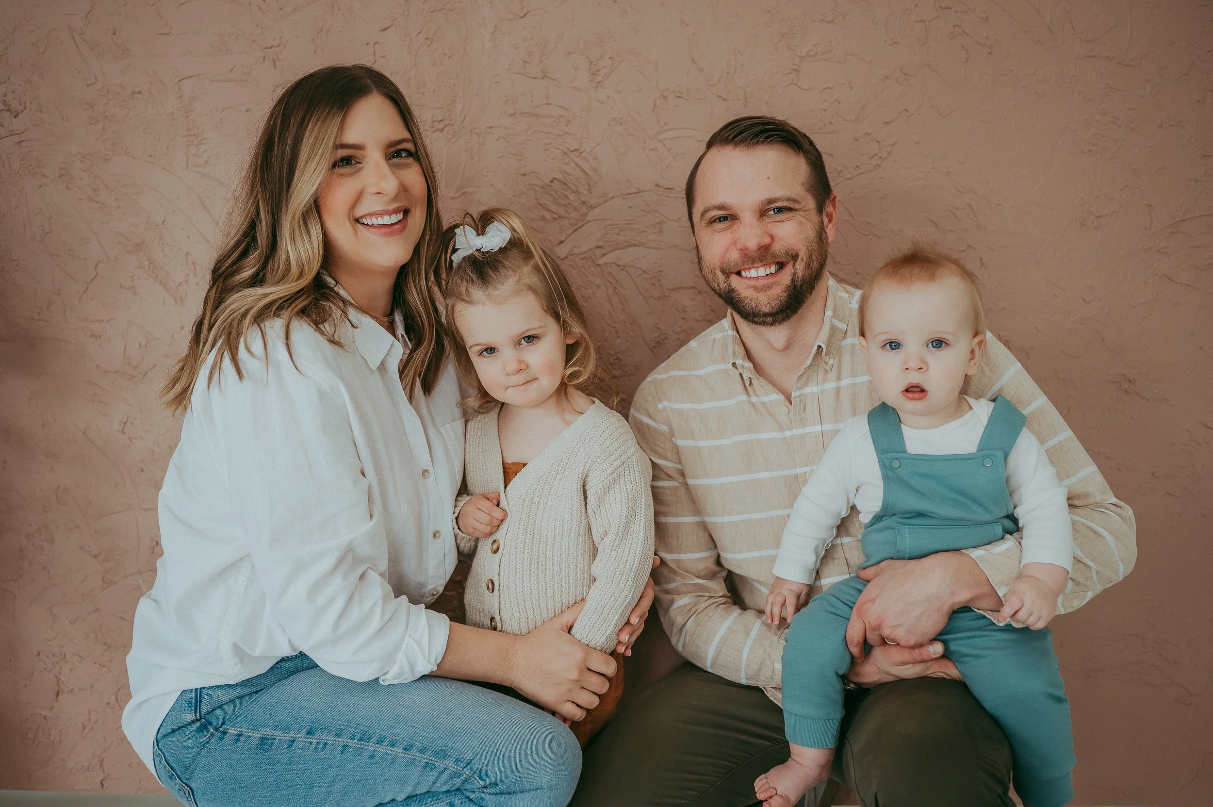 Family smiling in studio photos session