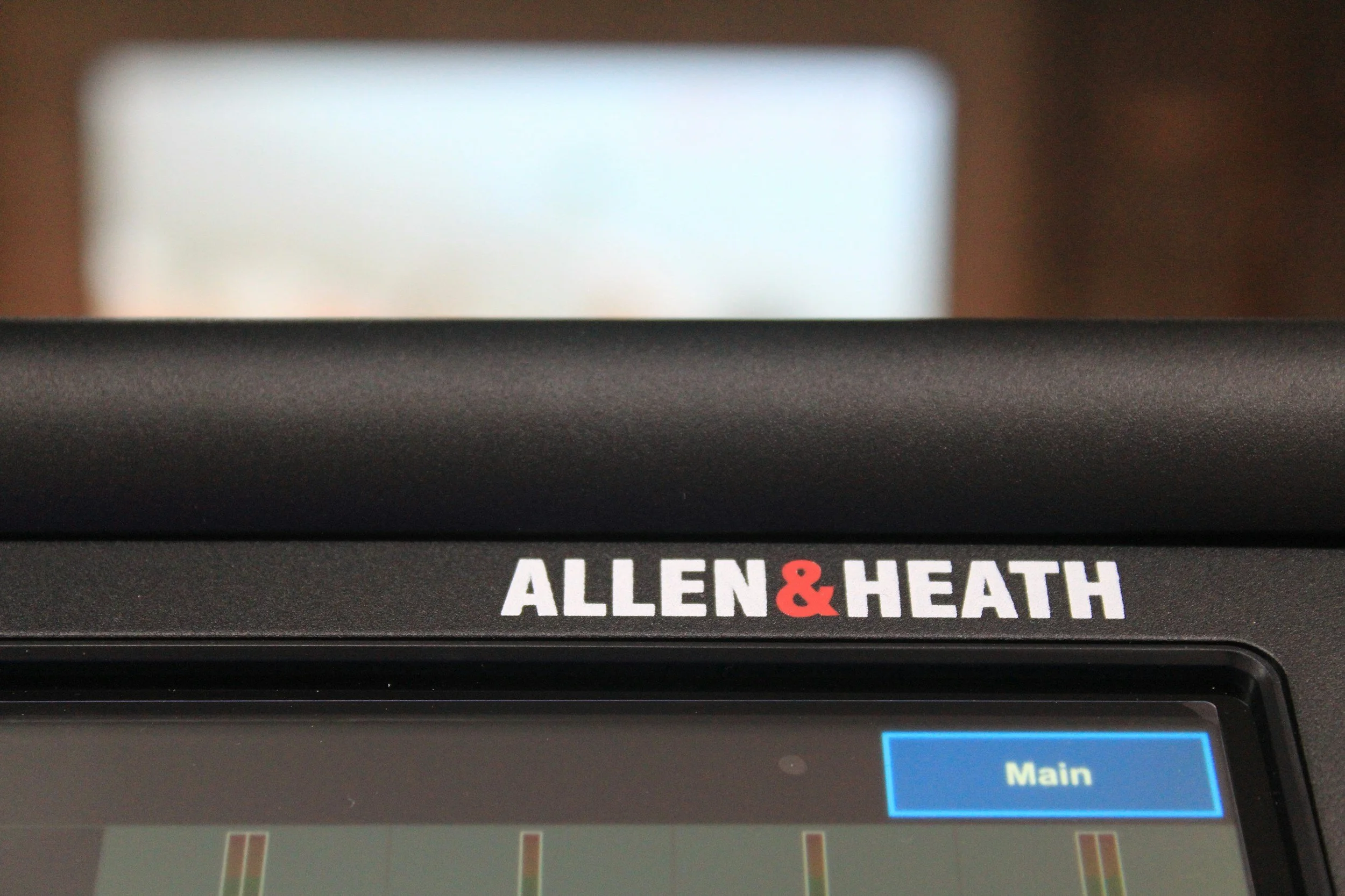 Allen & Heath digital mixer detail with illuminated controls.