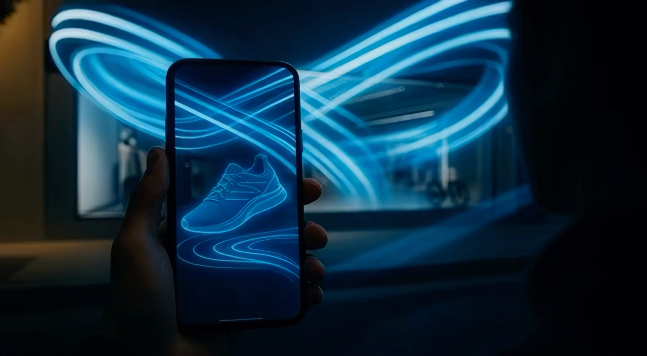 A person holds a smartphone with an outline of a sneaker displayed on the screen, while the background shows neon blue light trails forming a sneaker shape.