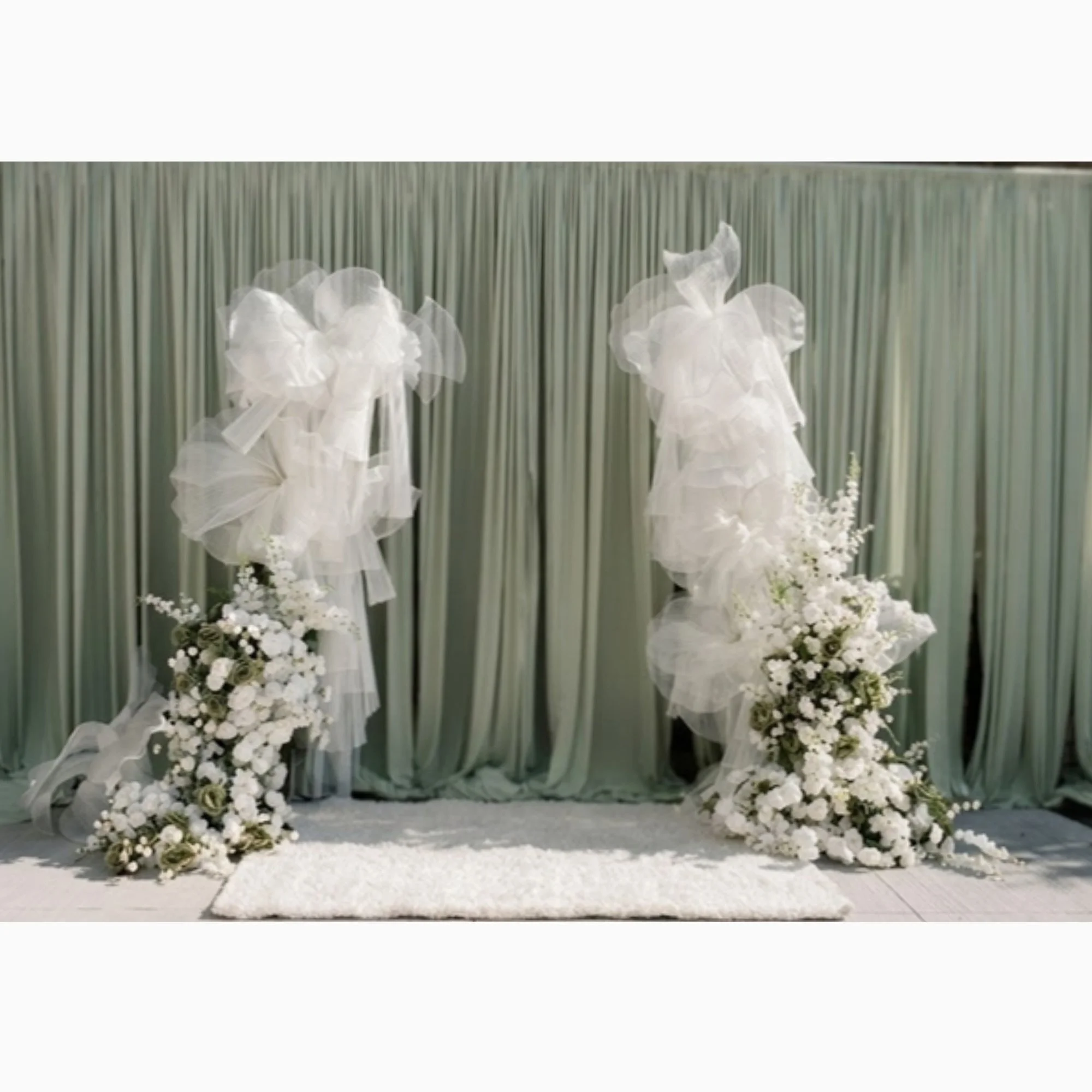 white-feather-and-floral-pillars-on-sage-drape.jpg