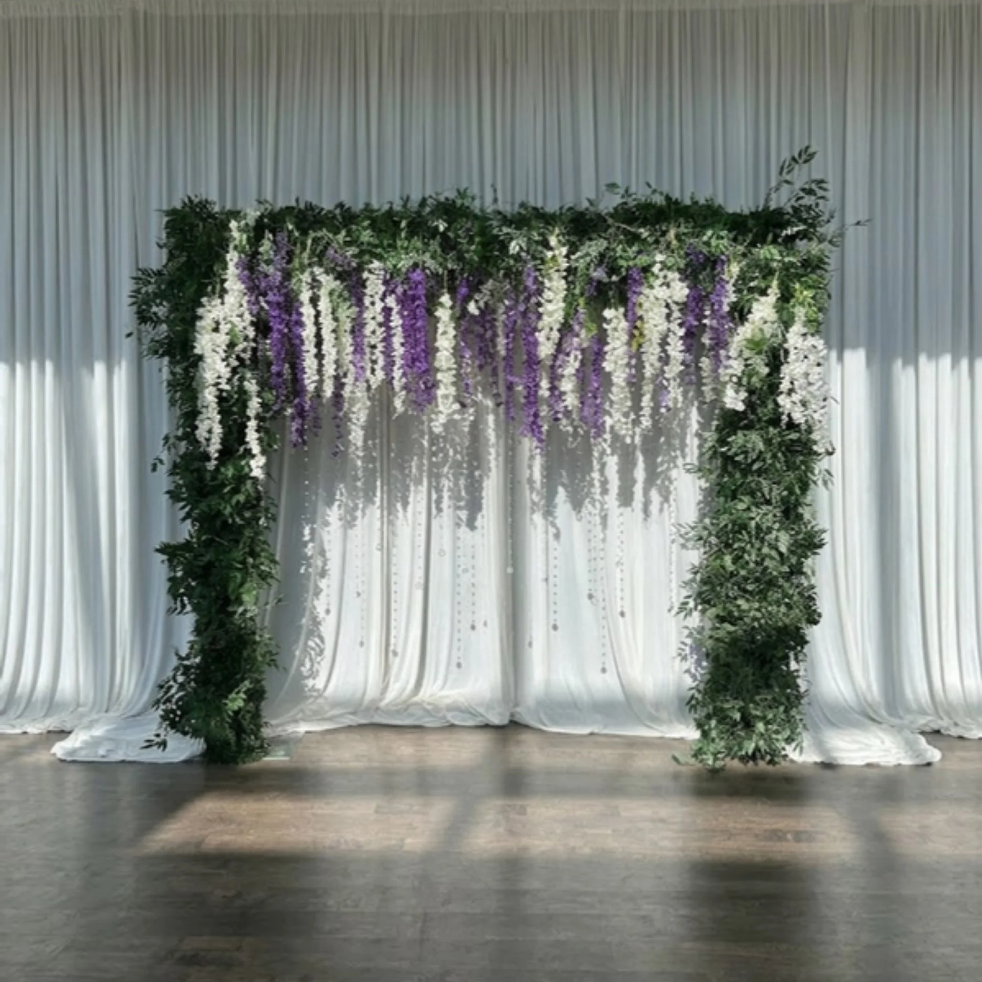 greenery-and-wisteria-arch-on-ivory-drape.jpg