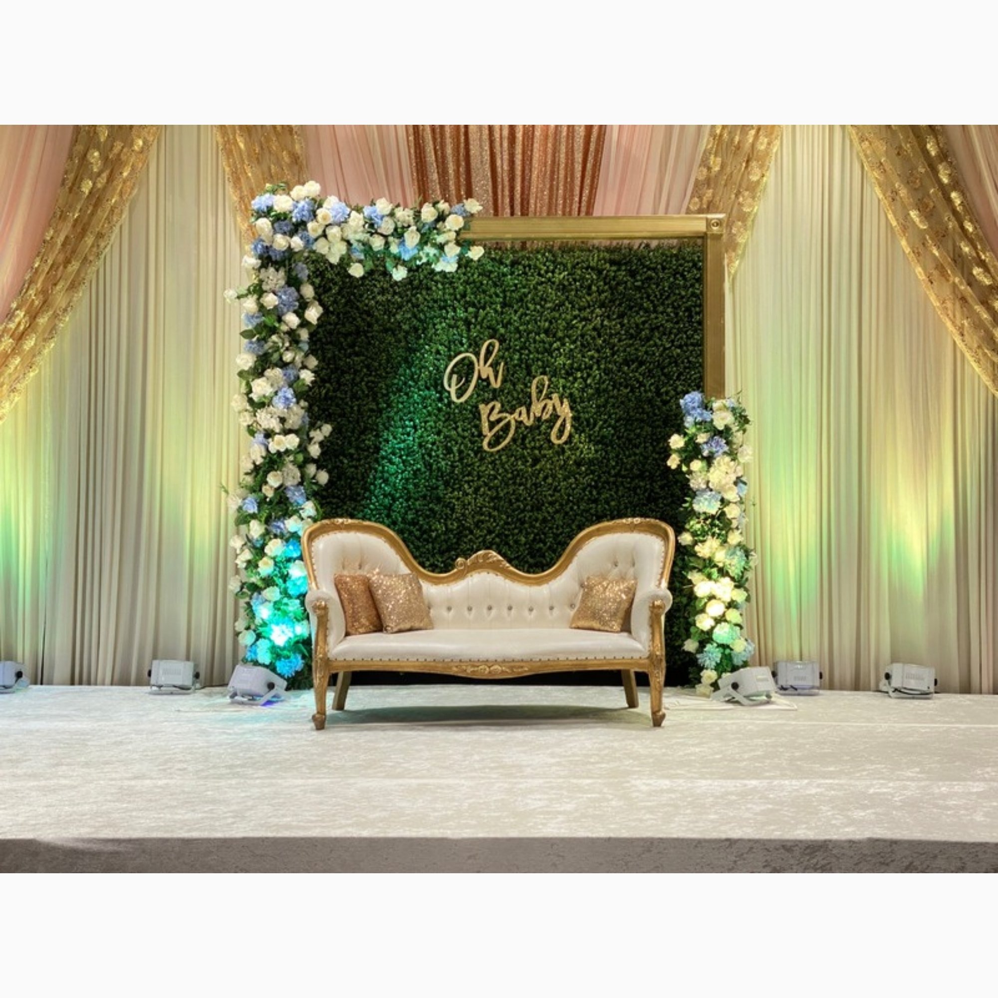 greenery-stage-with-loveseat-and-neon-sign.jpg