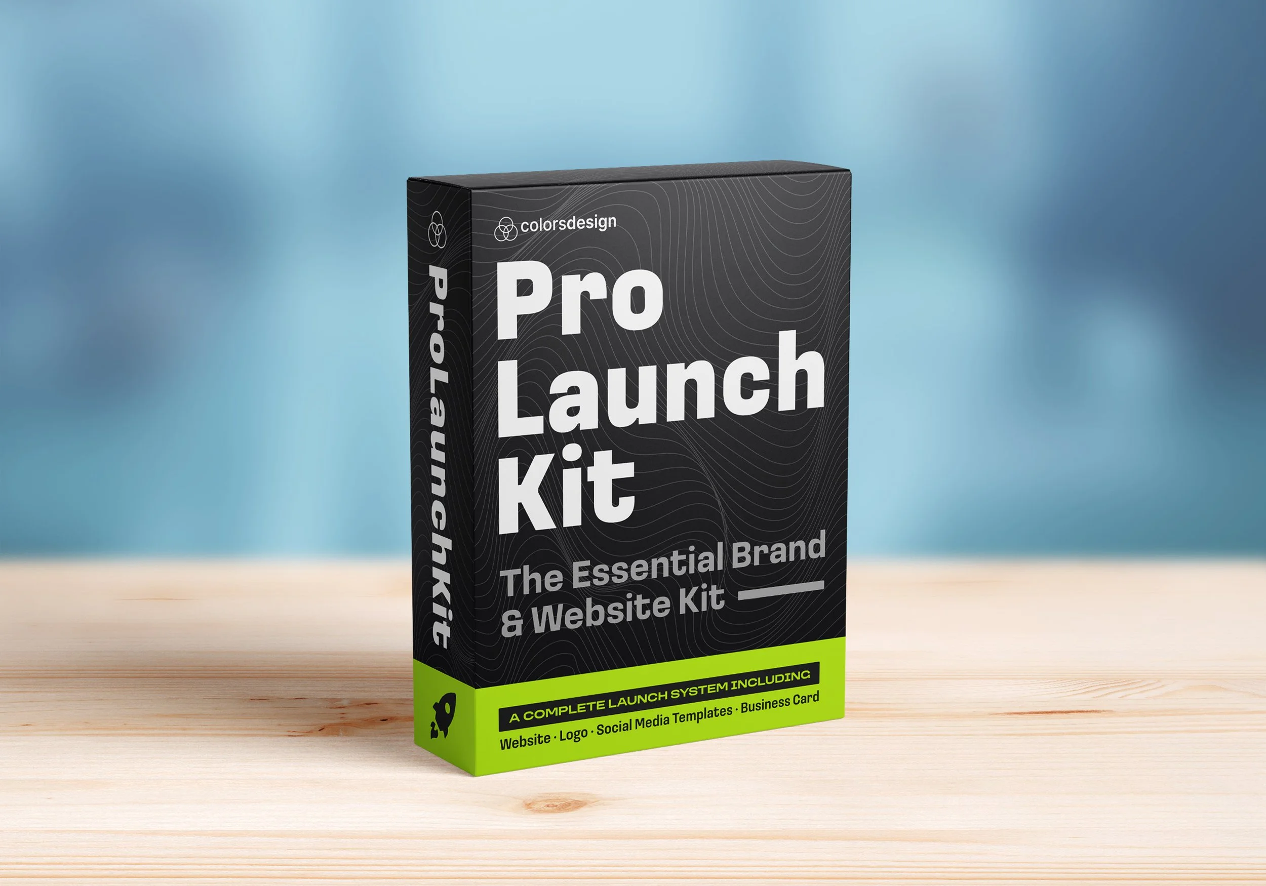 Black box packaging for 'Pro Launch Kit' on a wooden surface with a blurred blue background. The box includes white and neon green text indicating it is a website and branding launch system.