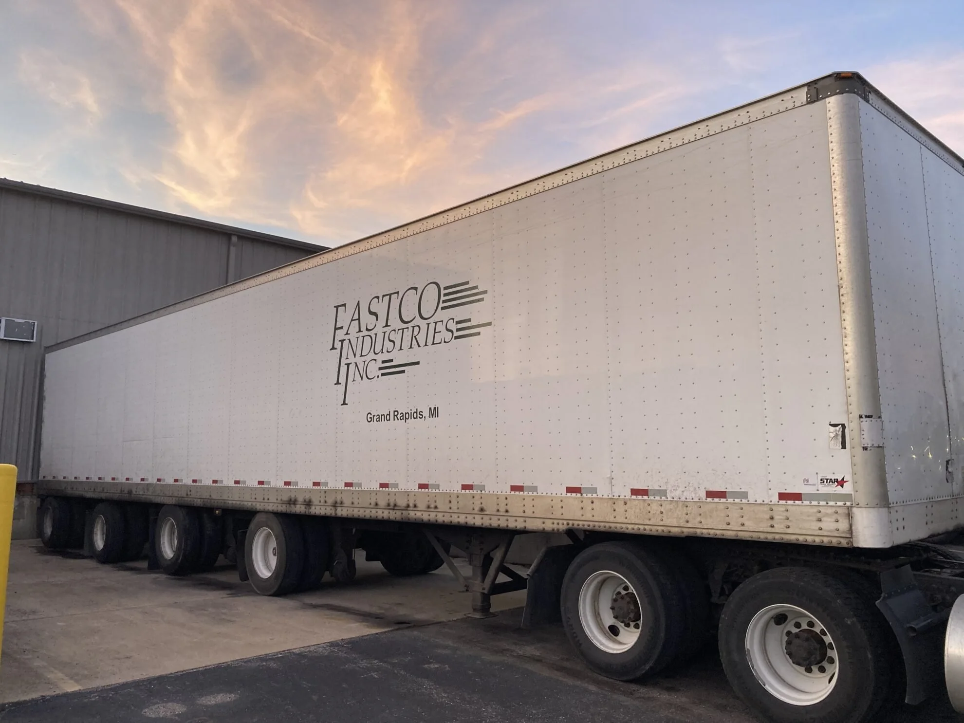A large white semi-trailer featuring the Fastco Industries Inc. logo parked outside the Grand Rapids, MI facility.