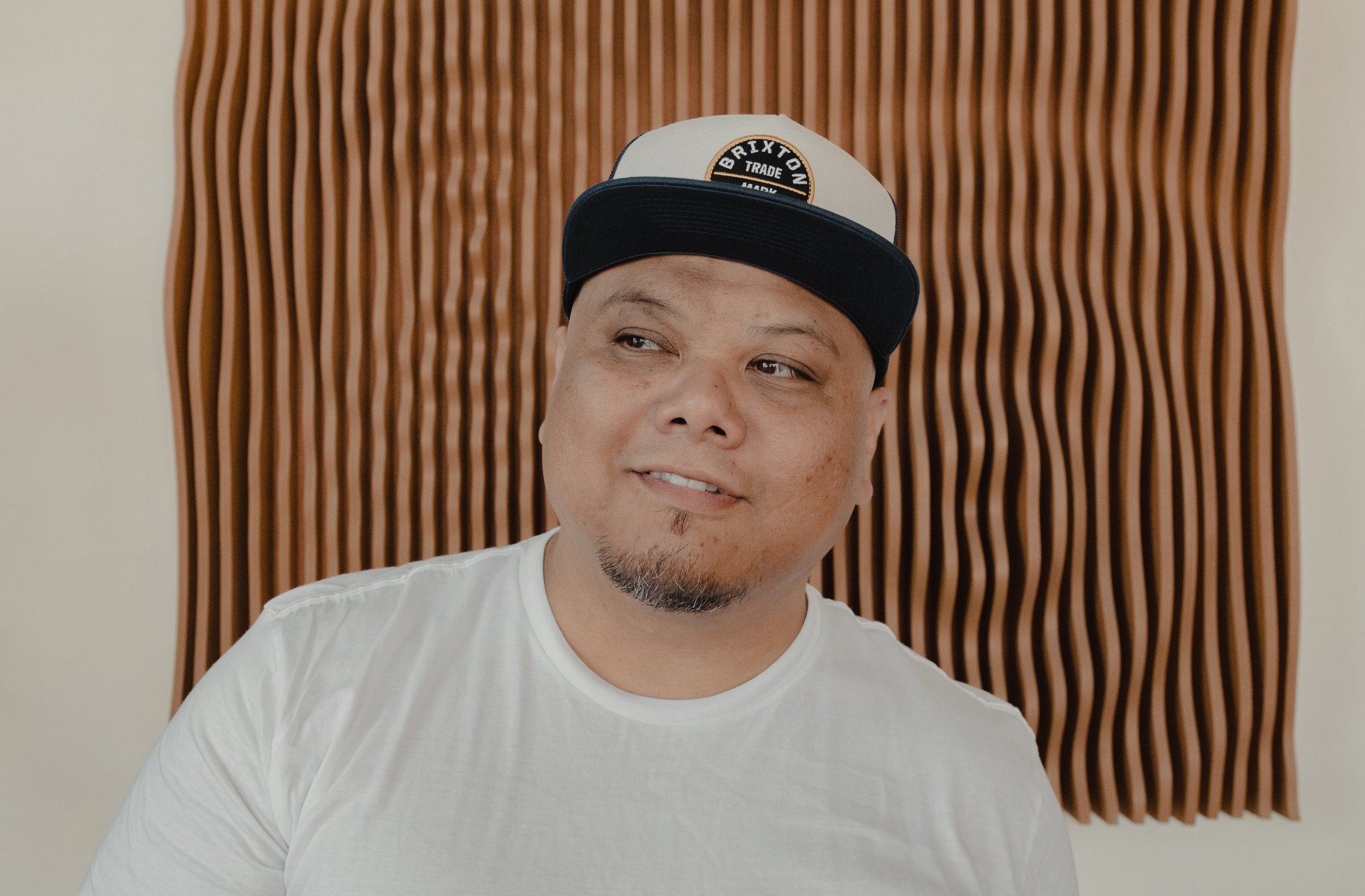 Man wearing a hat and smiling.