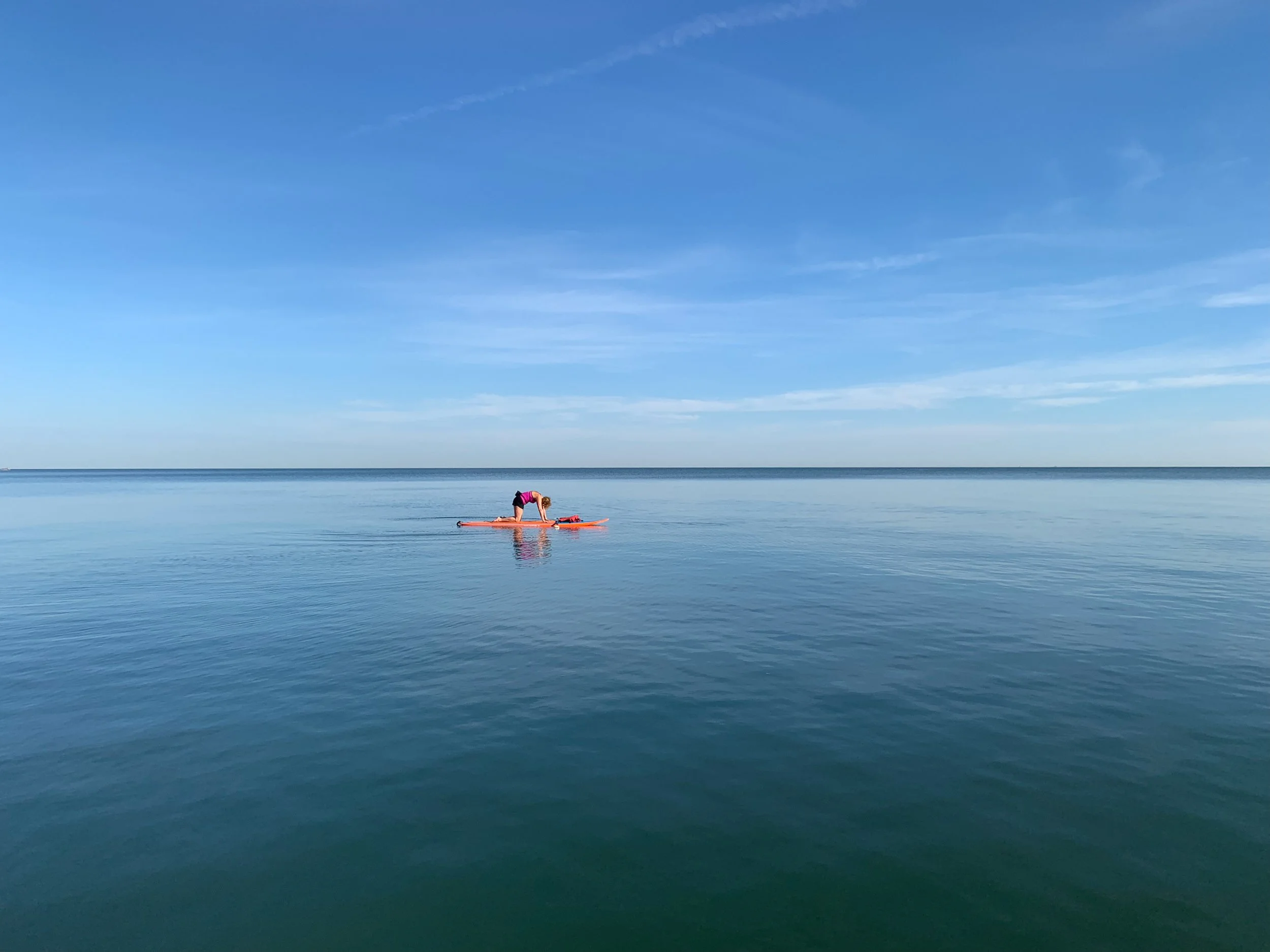 Solo paddle boarder  on open Lake