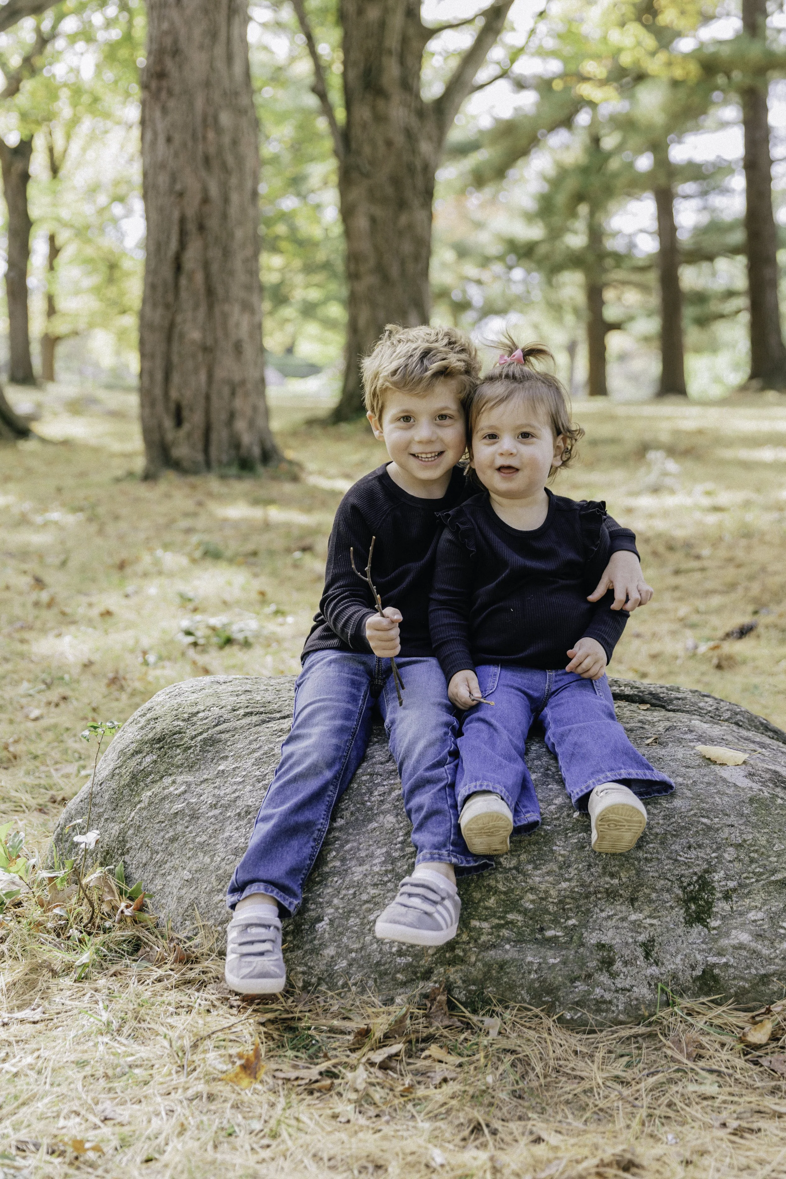 Two children sitting on rock outdoors — New York City family, portrait Bruce Park