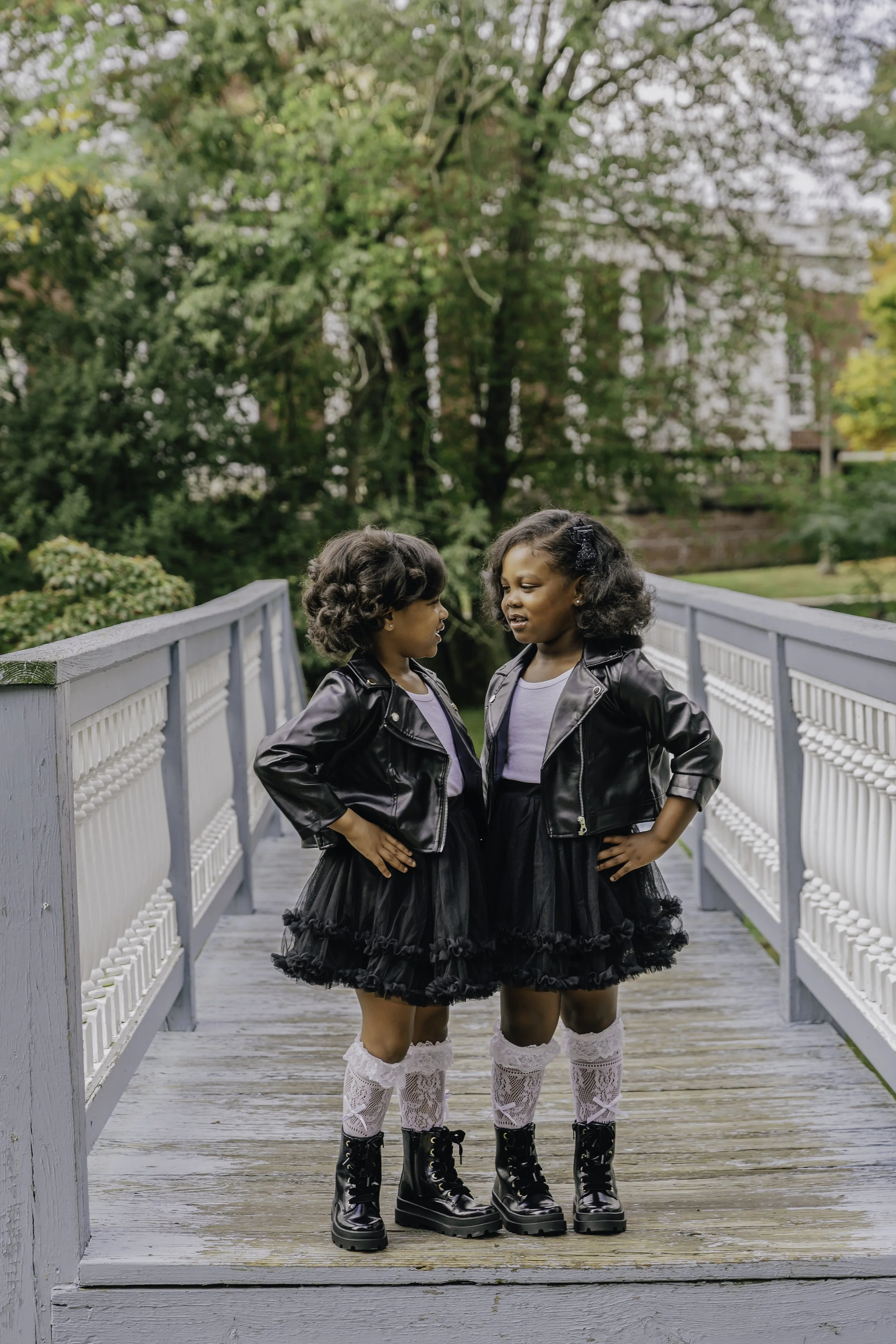 Two young girls dressed in black leather jackets. Sister photo in the Park. Documentary family photographer in New York City 