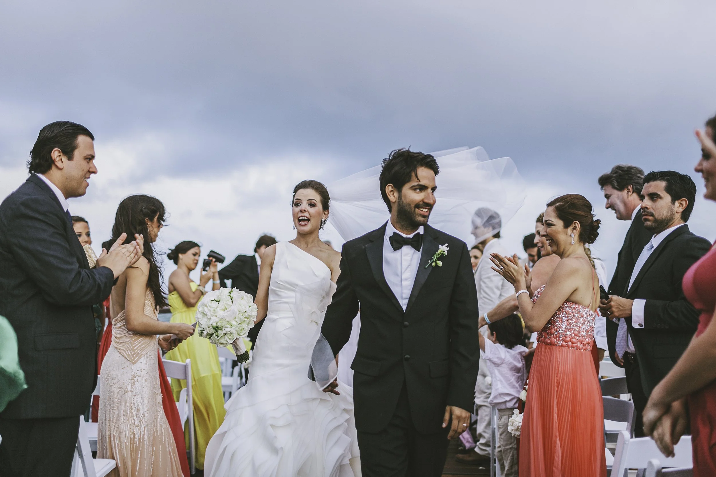 Bride and groom walking down aisle outdoors in Tulum — destination wedding photography