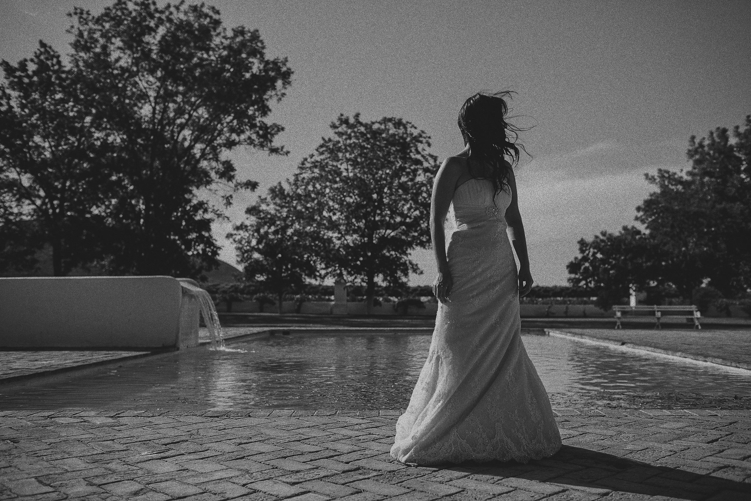 Bride near fountain at sunset — destination wedding photography