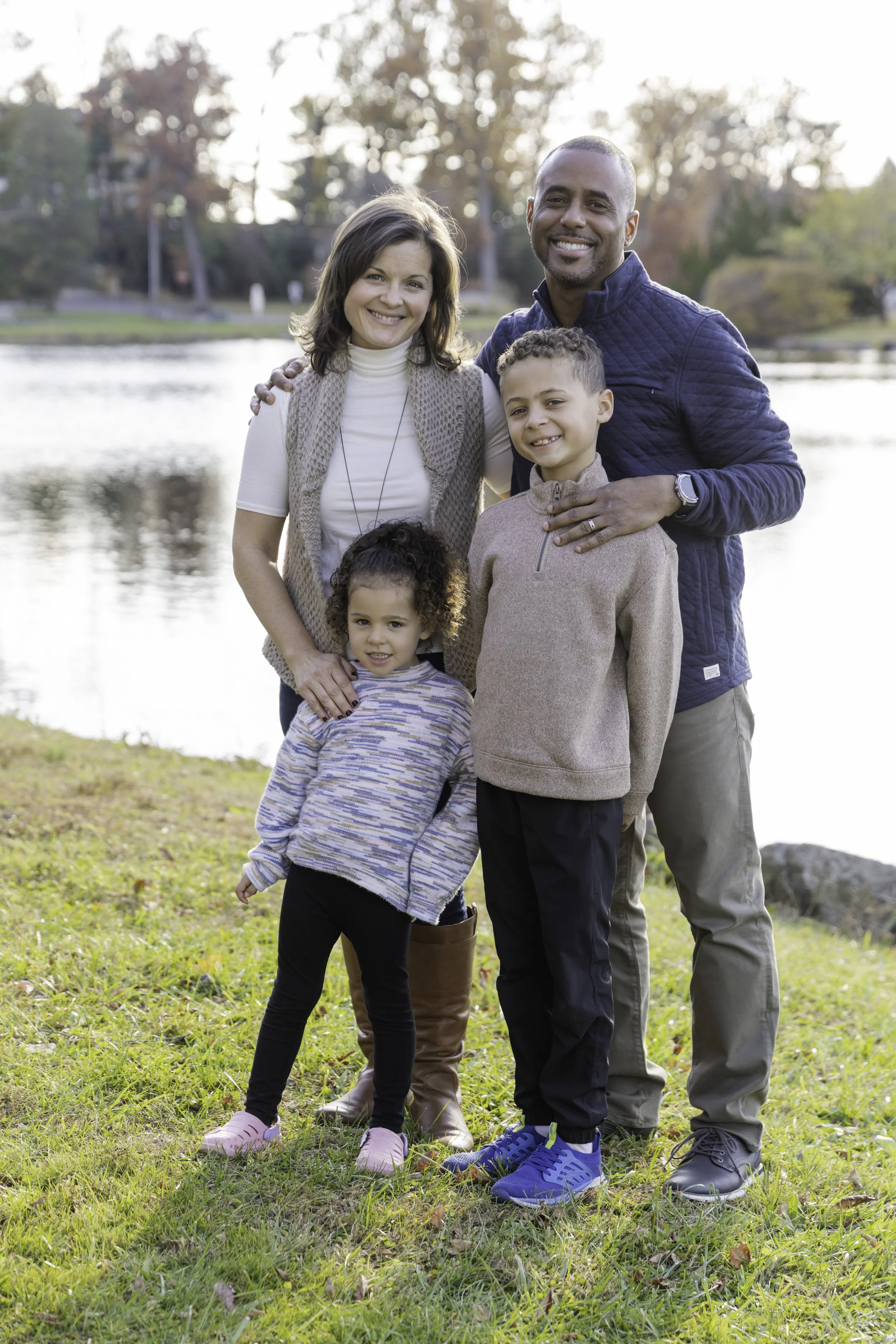 Family of four outdoors in lush garden with trees — Connecticut family lifestyle photography