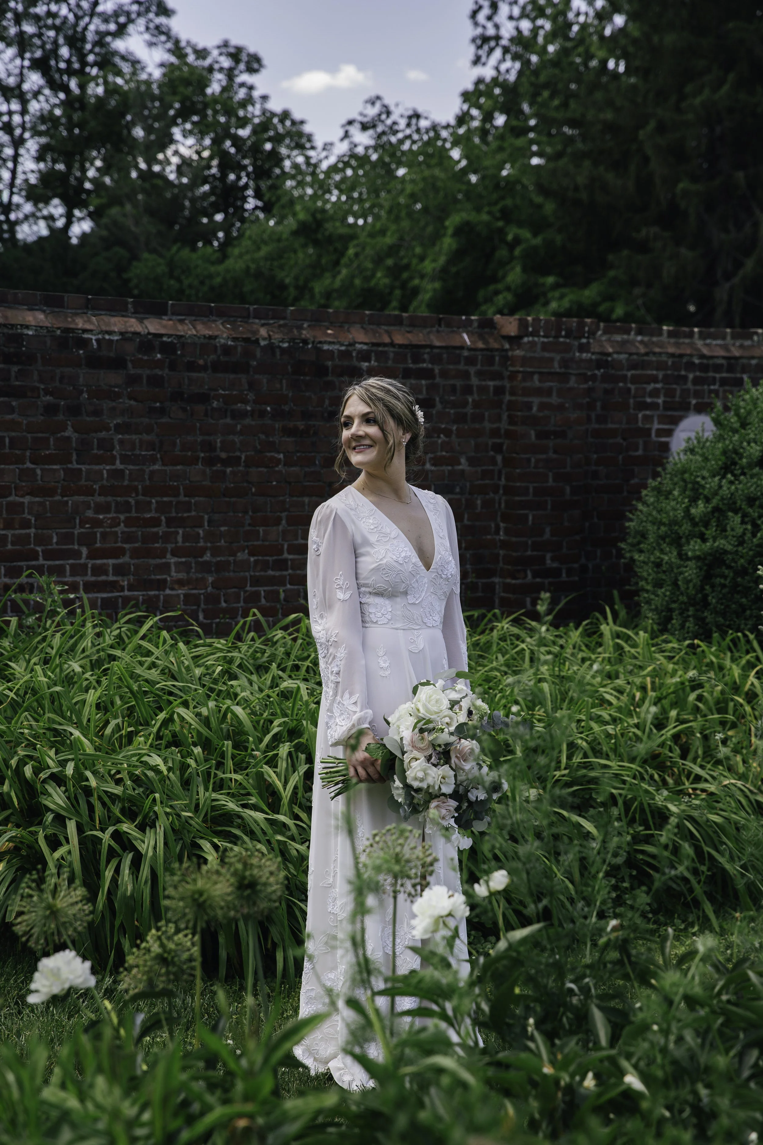 Bride with floral bouquet in garden — New York City wedding photography