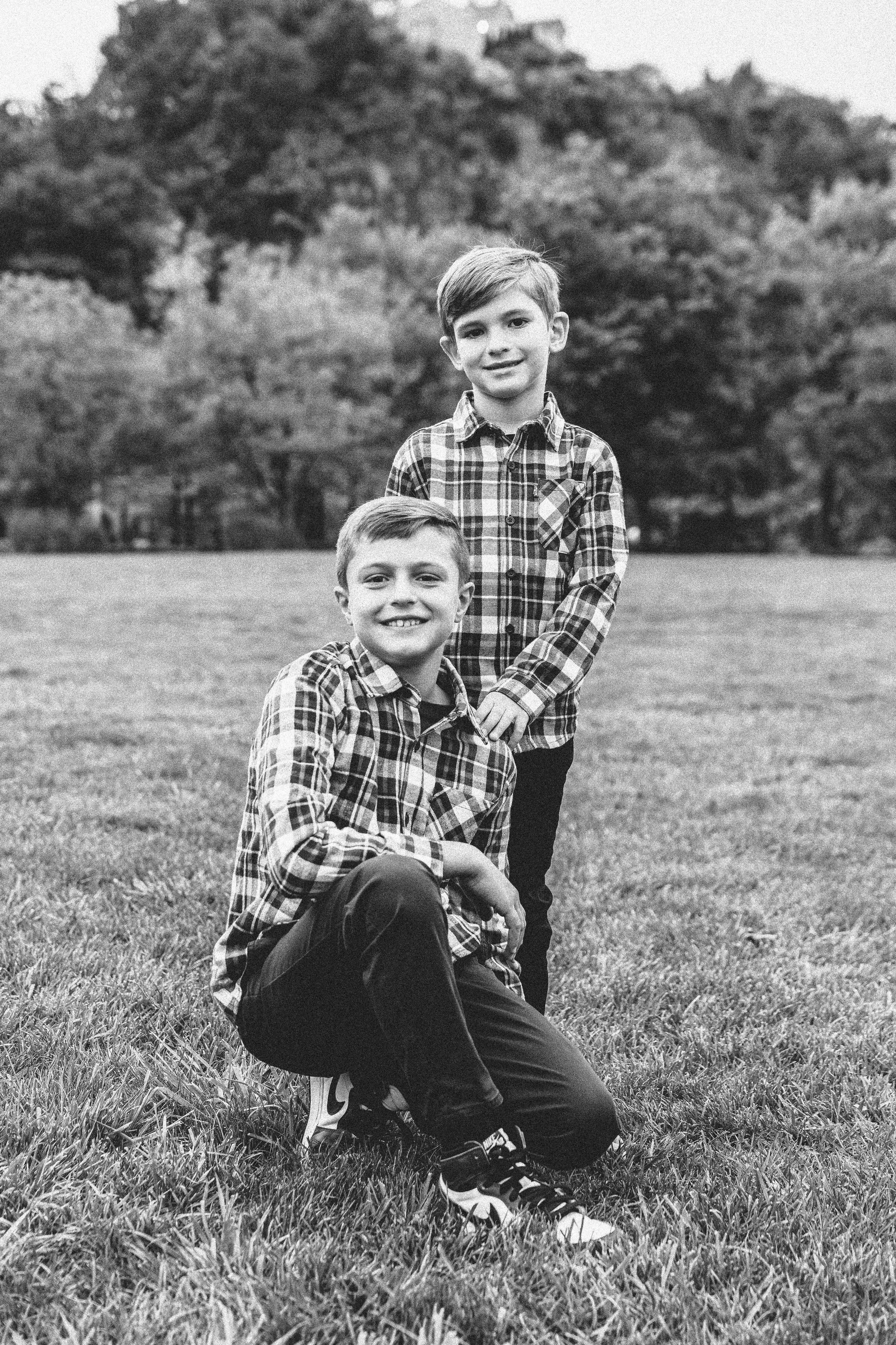 Two boys in plaid shirts outdoors near skyline — New York City family lifestyle photography