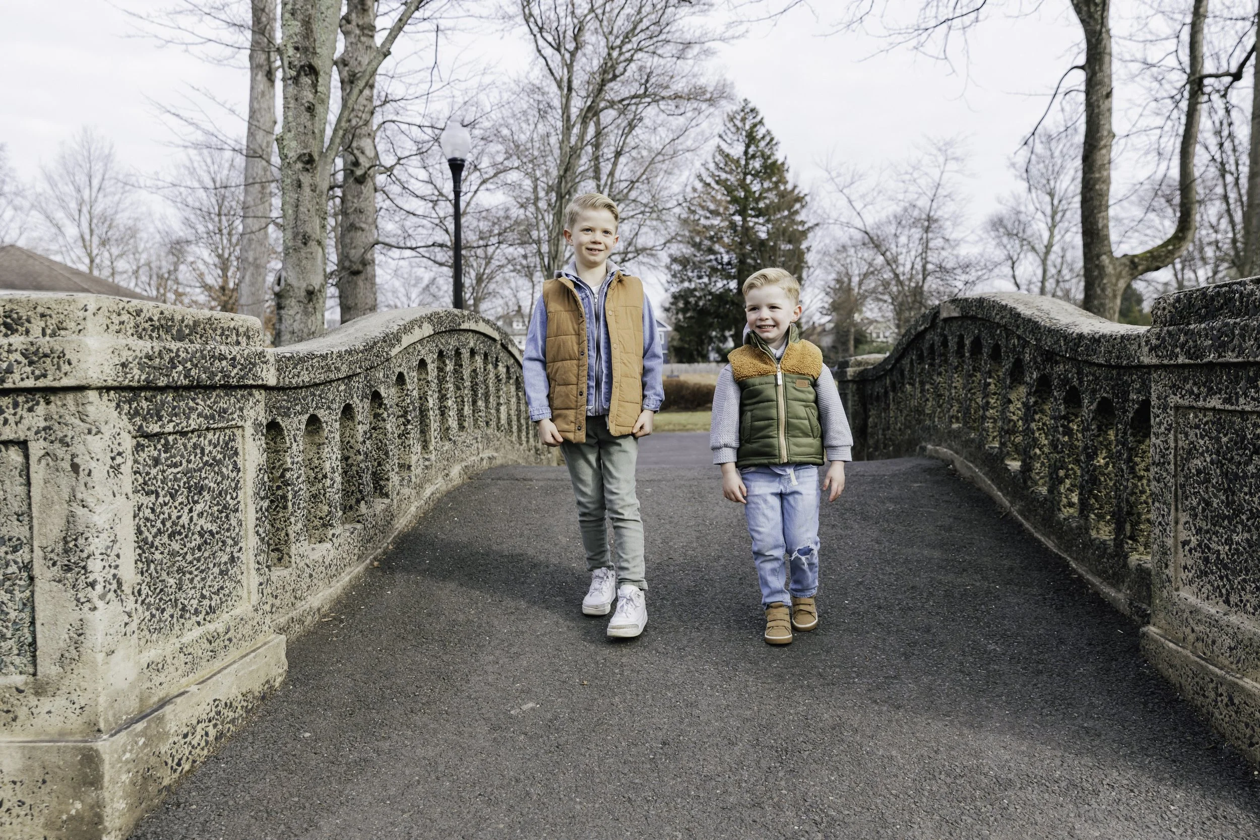 Two young boys walking on a park bridge — New York City family photography