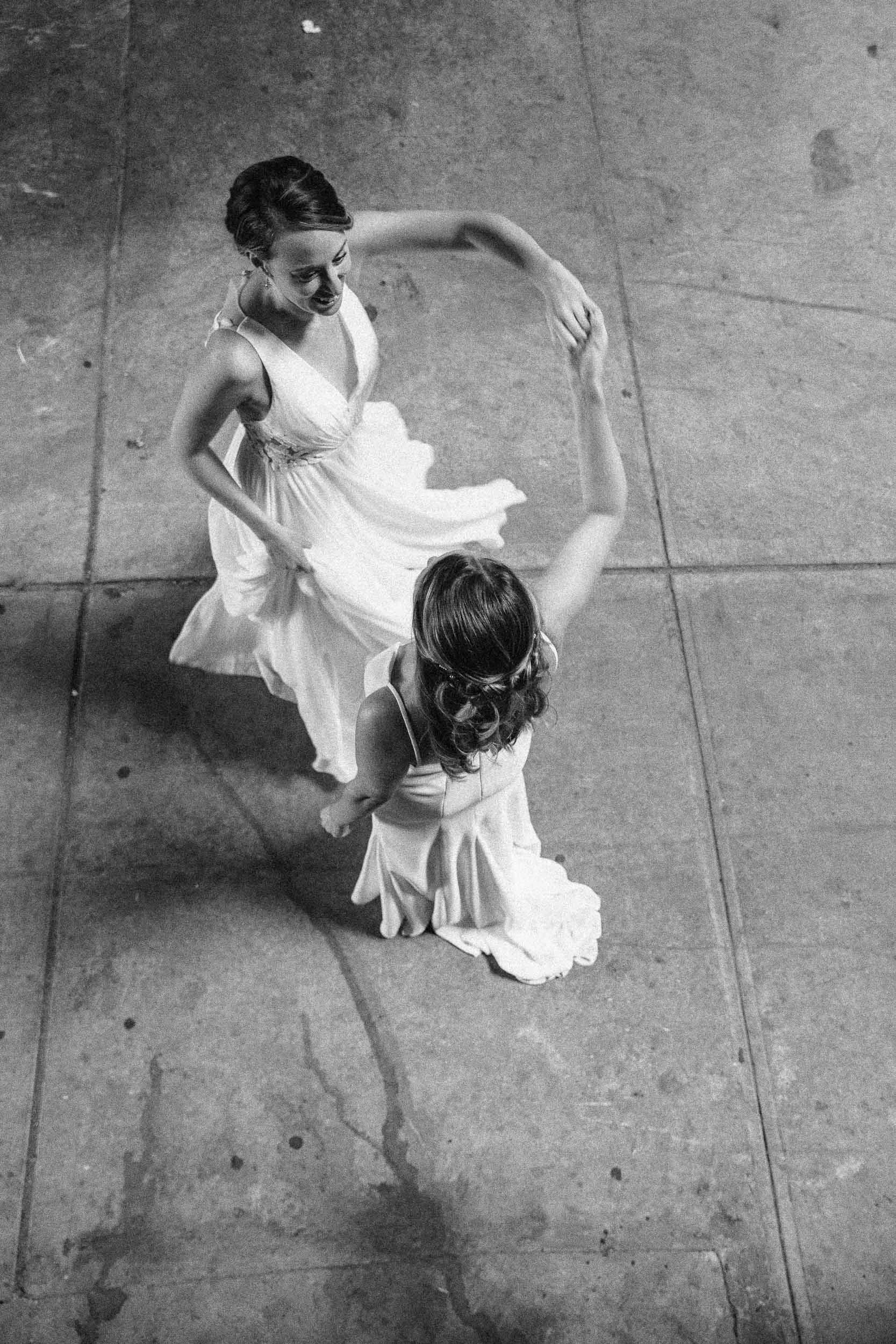 Two women dancing on a concrete floor - New York City Wedding Photographer