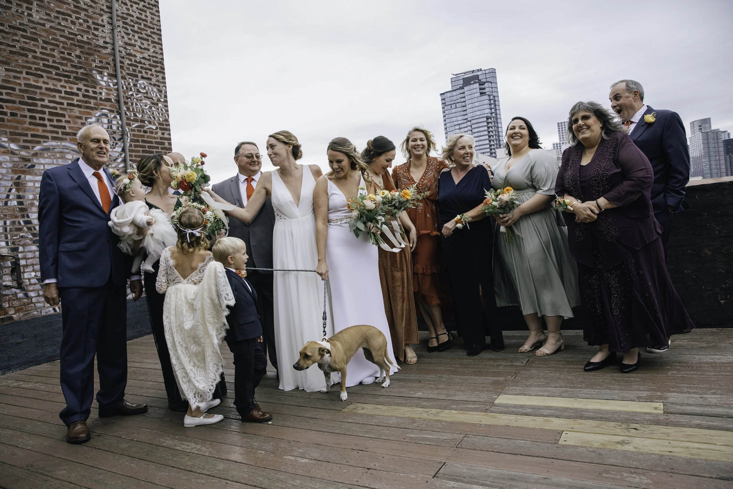 Group of people at a wedding, including bridesmaids, groomsmen, children, and a dog, Documentary wedding photography in NYC