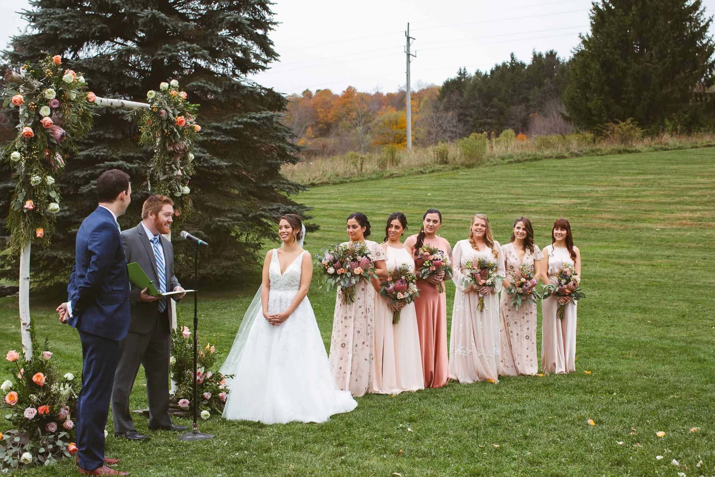 Outdoor wedding ceremony under floral arch in New York City — NYC wedding photography