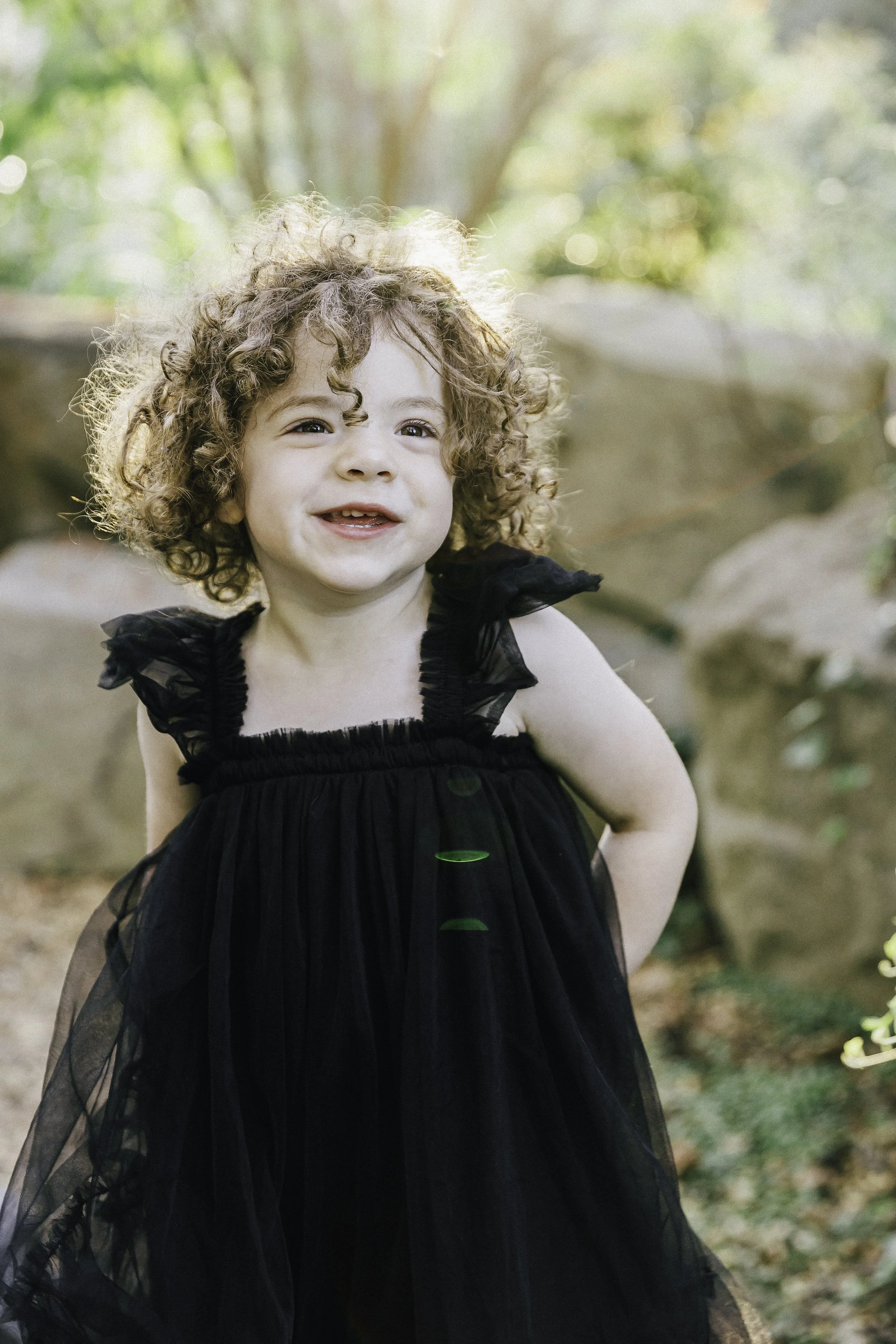 Young girl with curly blonde hair standing in park — NYC family photography