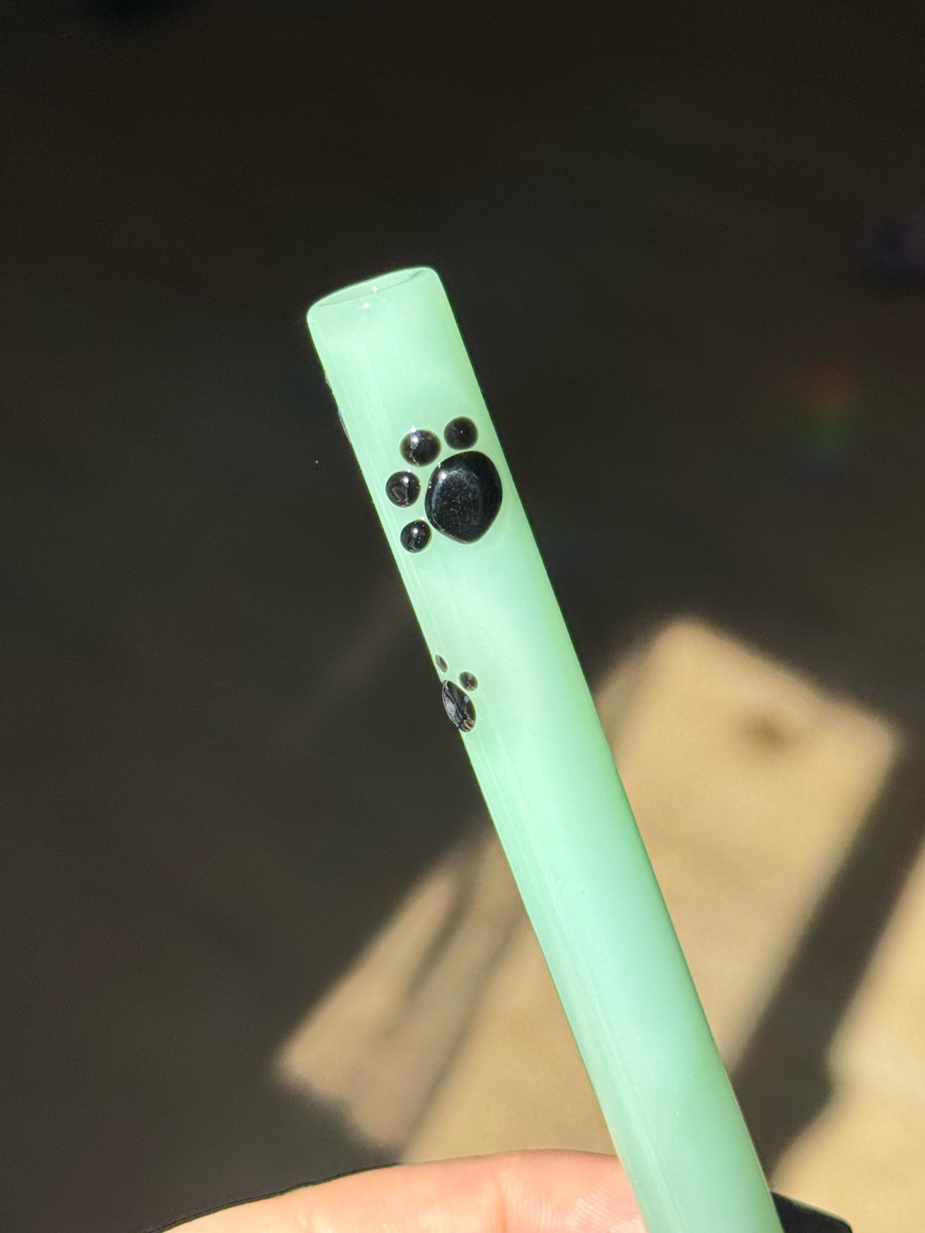 Mint green glass straw with black paw prints