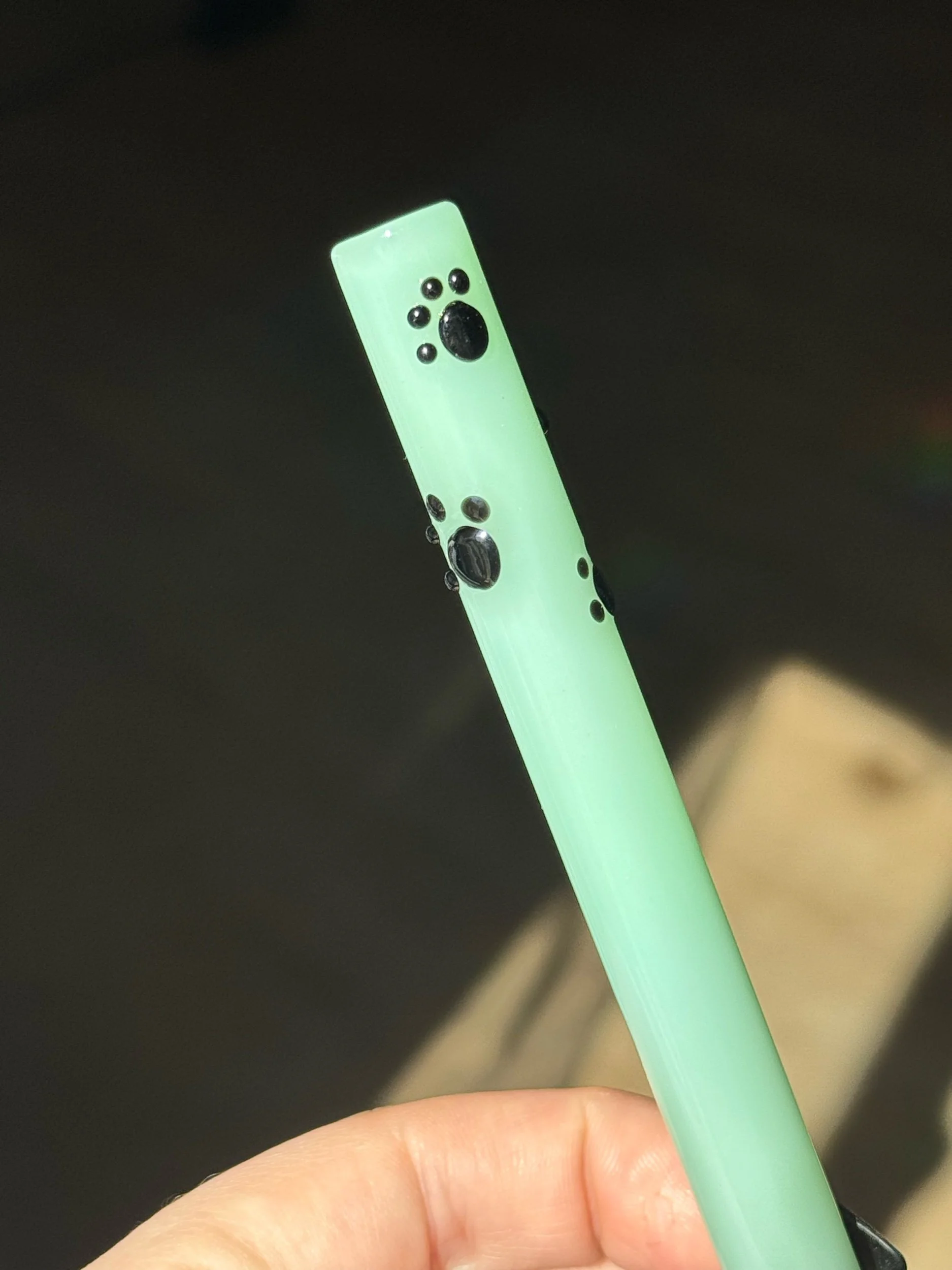 Mint green glass straw with black paw prints
