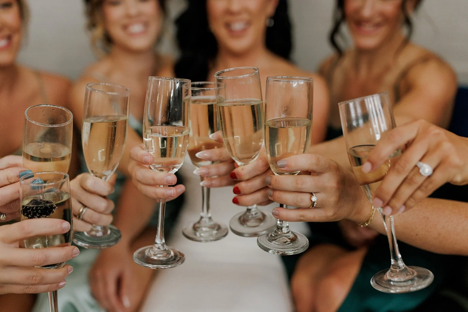 Group of women celebrating and toasting with glasses of champagne.