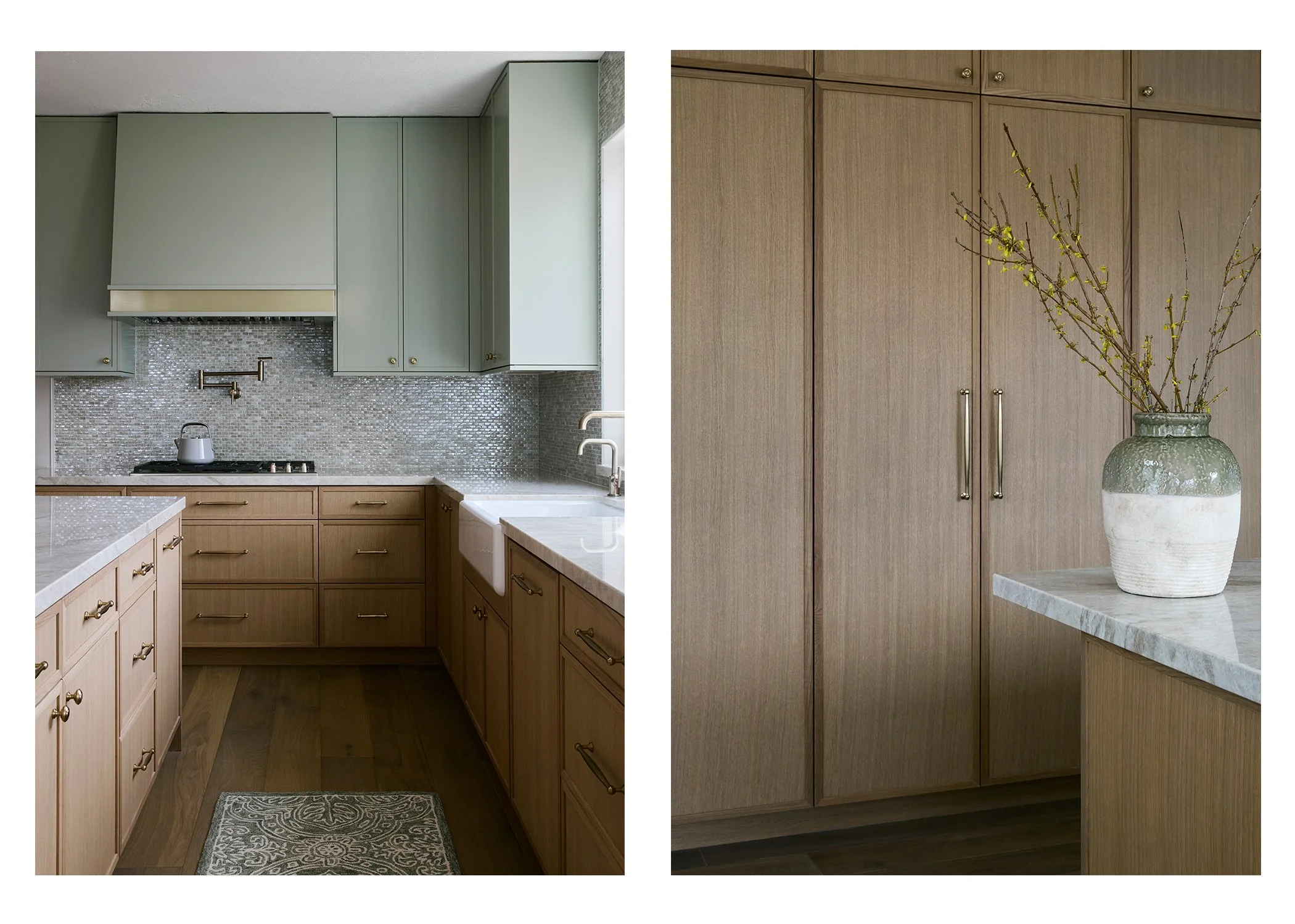 Interior view of a kitchen with sage green upper cabinets, natural wood lower cabinets, a marble countertop, and a mosaic backsplash on the left; a wooden pantry with a vase of branches on the right.
